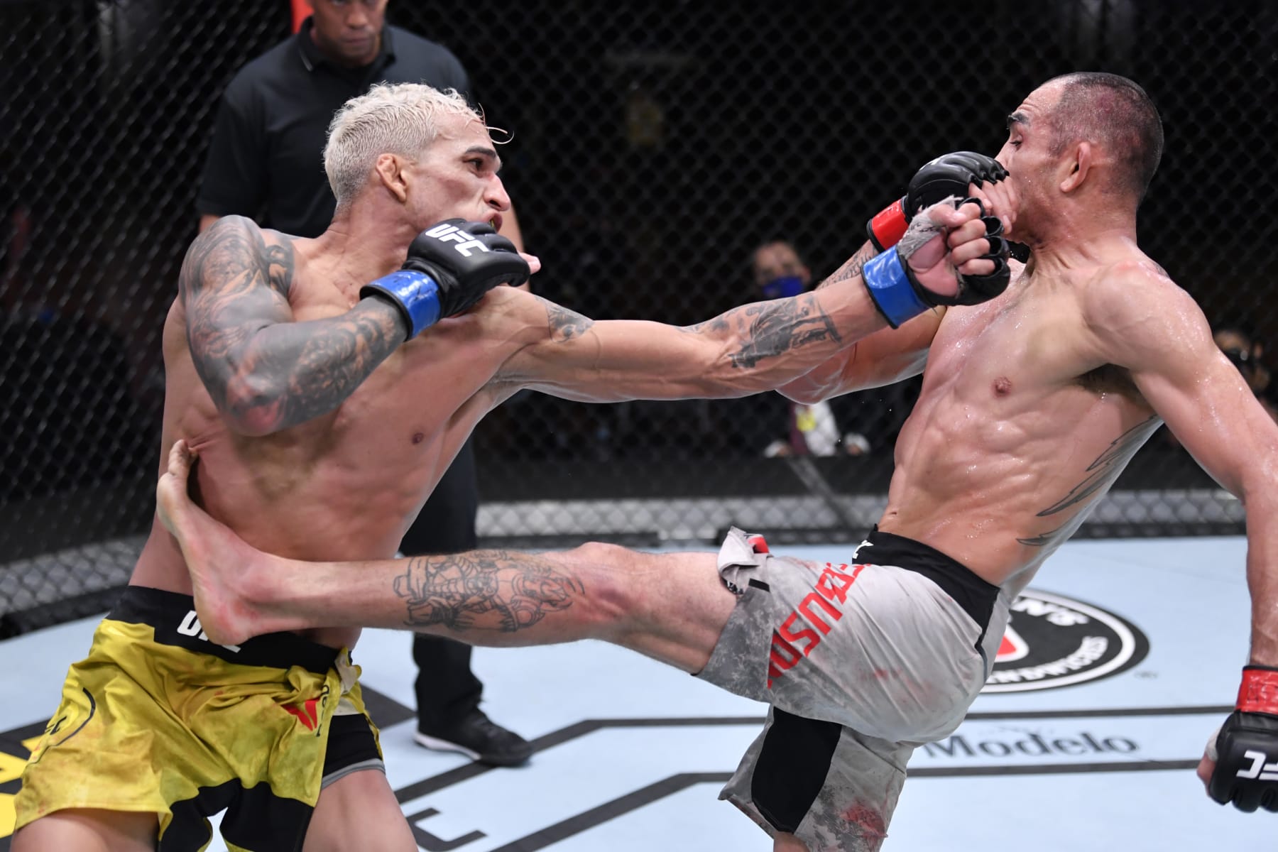 LAS VEGAS, NEVADA - DECEMBER 12:  (L-R) Charles Oliveira of Brazil and Tony Ferguson exchange strikes in their lightweight bout during the UFC 256 event at UFC APEX on December 12, 2020 in Las Vegas, Nevada. (Photo by Jeff Bottari/Zuffa LLC)