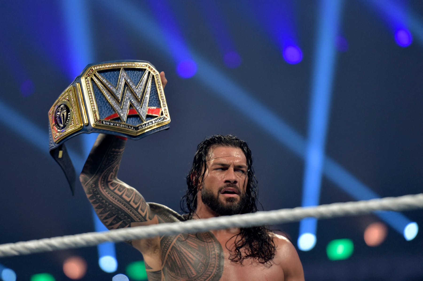 Roman Reigns celebrates after defeating Bill Goldberg during the 2022 WWE Elimination Chamber at the Jeddah Super Dome in Saudi Arabia's Red Sea coastal city of Jeddah on February 19, 2022. (Photo by Amer HILABI / AFP) (Photo by AMER HILABI/AFP via Getty Images)