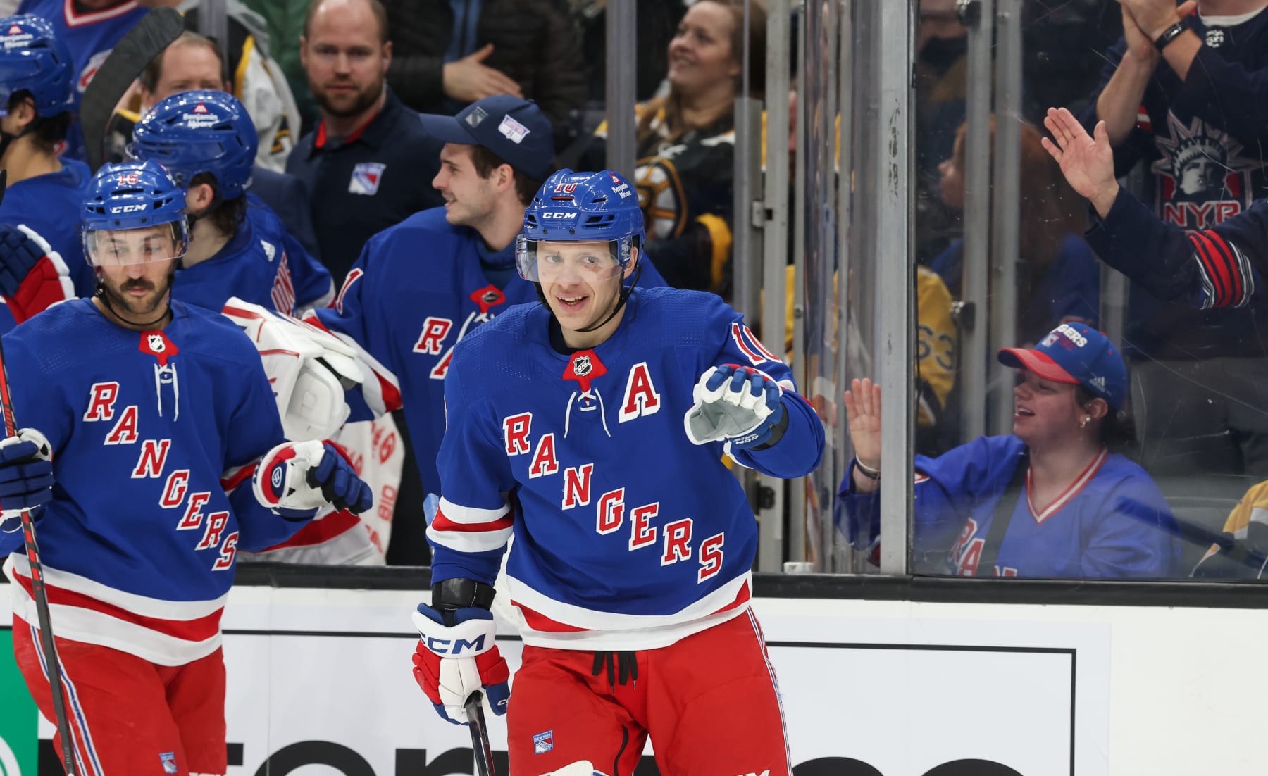 BOSTON, MASSACHUSETTS - MARCH 21: Artemi Panarin #10 of the New York Rangers celebrates an empty-net goal with his teammates, his third goal of the game, for a hat trick against the Boston Bruins during the third period at the TD Garden on March 21, 2024 in Boston, Massachusetts. The Rangers won 5-2. (Photo by Richard T Gagnon/Getty Images)