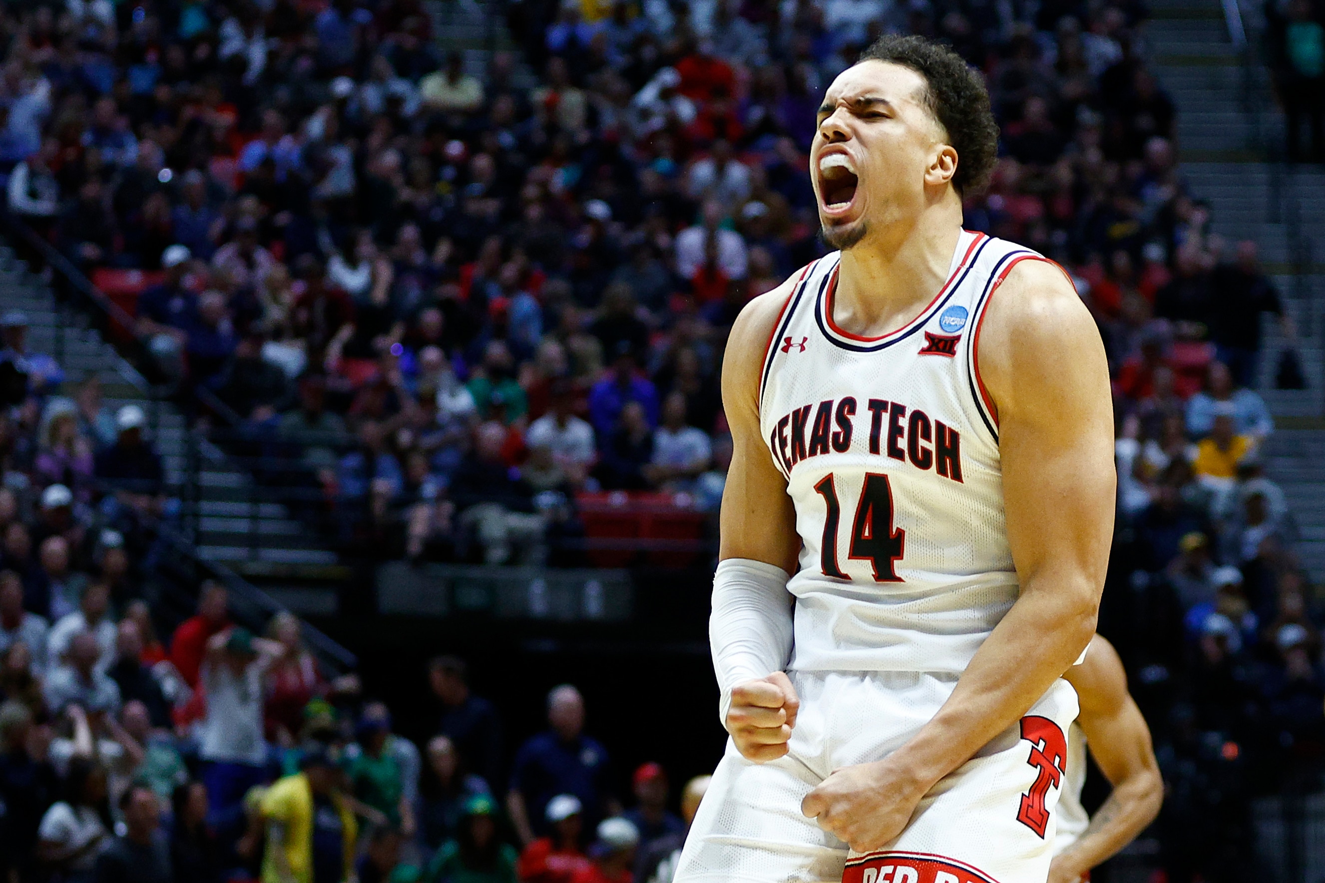 SAN DIEGO, CALIFORNIA - MARCH 20: Marcus Santos-Silva #14 of the Texas Tech Red Raiders celebrates during the second half against the Notre Dame Fighting Irish in the second round game of the 2022 NCAA Men's Basketball Tournament at Viejas Arena at San Diego State University on March 20, 2022 in San Diego, California. (Photo by Ronald Martinez/Getty Images)