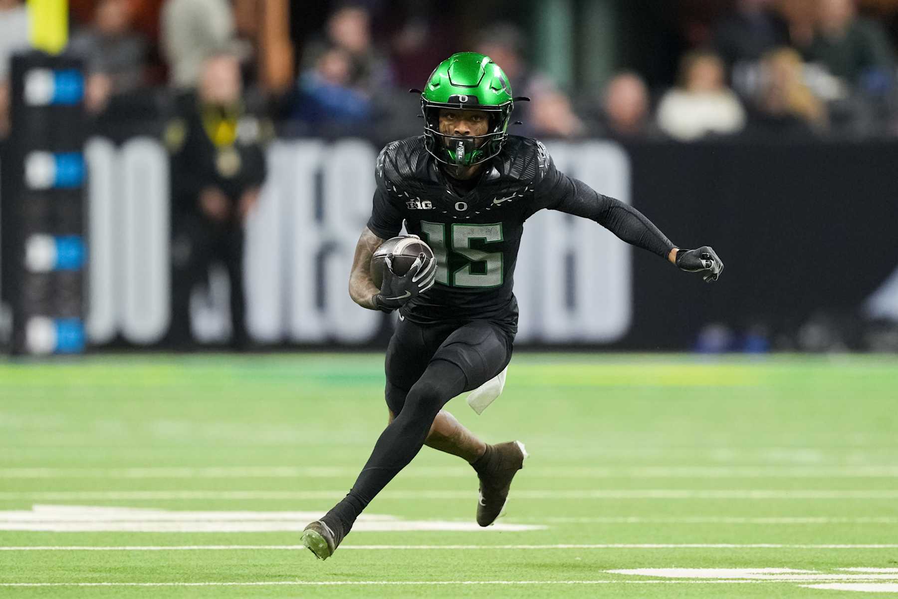 INDIANAPOLIS, INDIANA - DECEMBER 07: Tez Johnson #15 of the Oregon Ducks runs with the ball in the third quarter against the Penn State Nittany Lions of the 2024 Big Ten Football Championship at Lucas Oil Stadium on December 07, 2024 in Indianapolis, Indiana. (Photo by Dylan Buell/Getty Images)