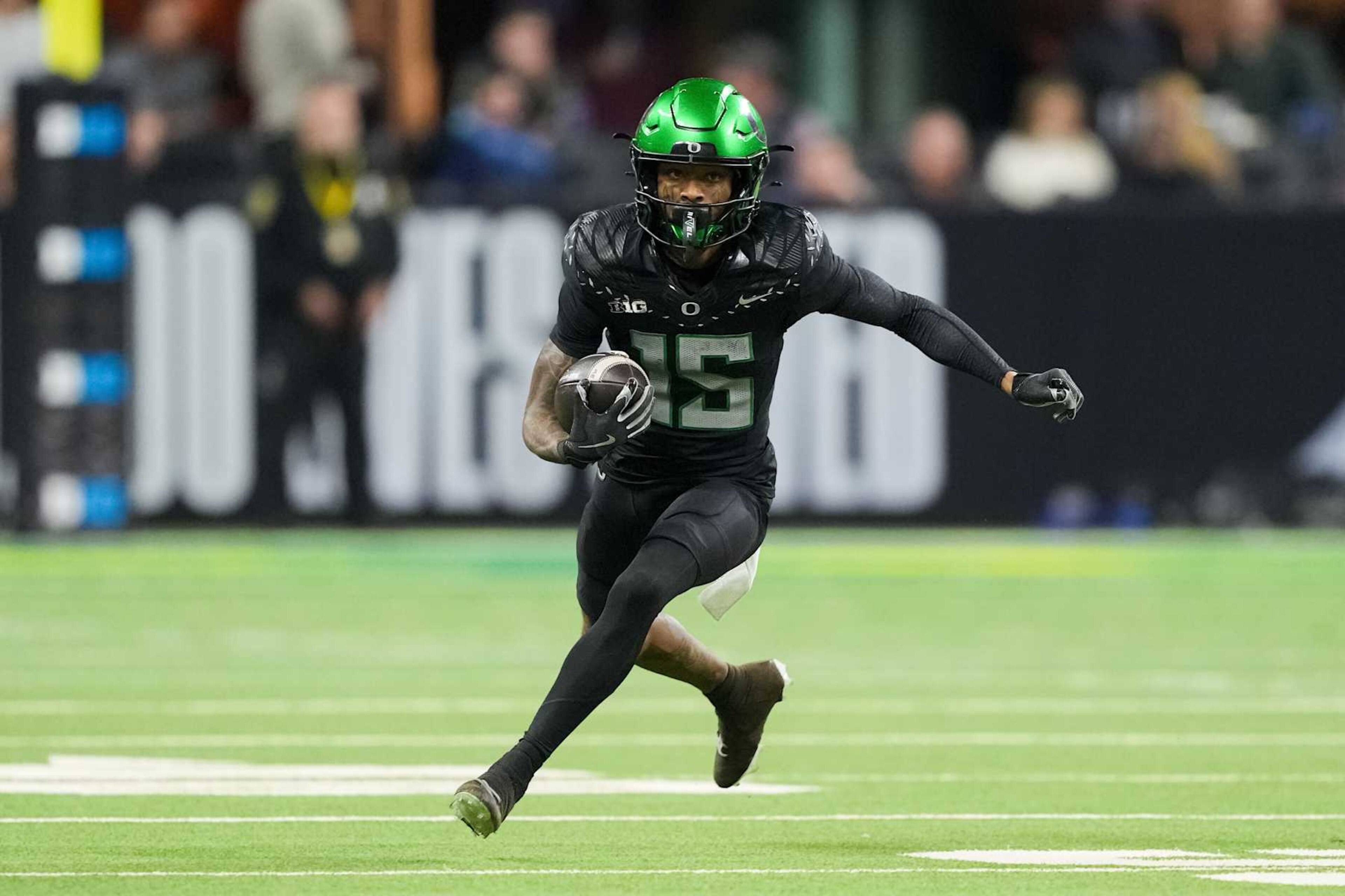 INDIANAPOLIS, INDIANA - DECEMBER 07: Tez Johnson #15 of the Oregon Ducks runs with the ball in the third quarter against the Penn State Nittany Lions of the 2024 Big Ten Football Championship at Lucas Oil Stadium on December 07, 2024 in Indianapolis, Indiana. (Photo by Dylan Buell/Getty Images)