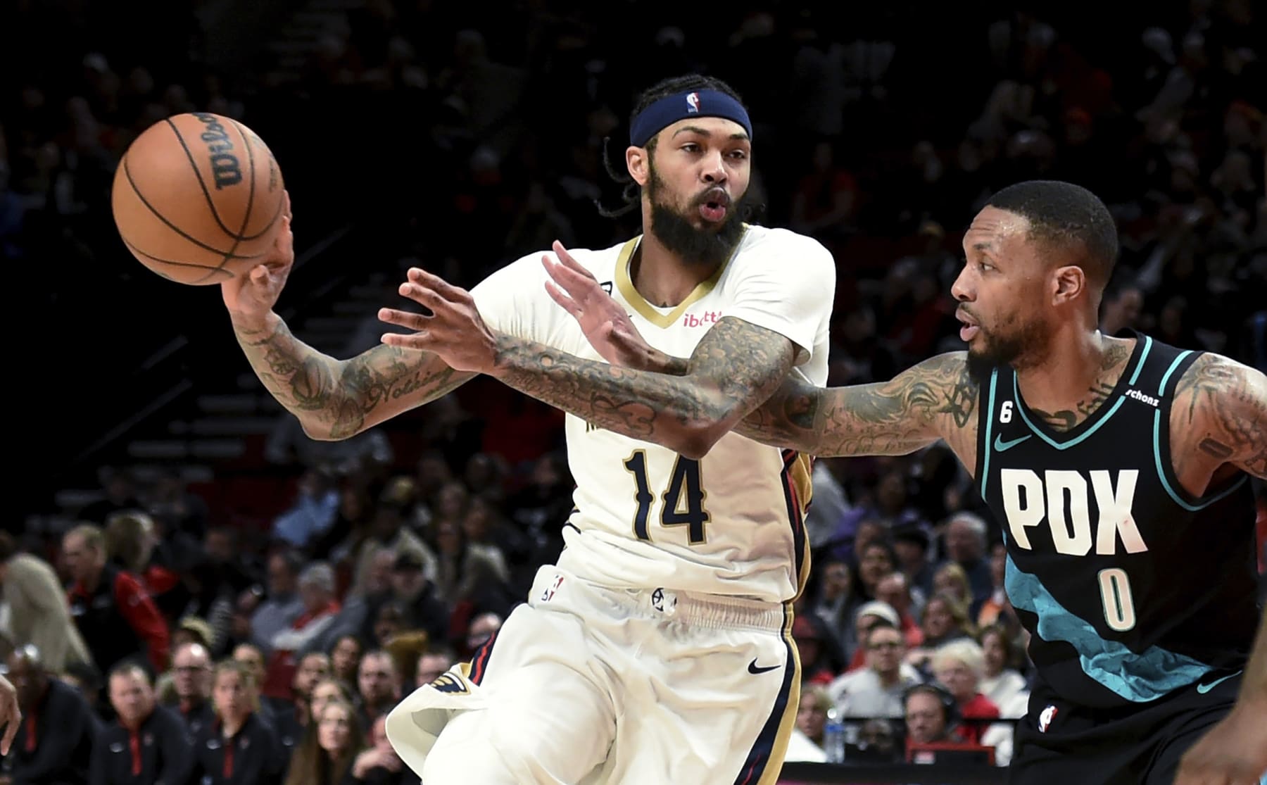 New Orleans Pelicans forward Brandon Ingram passes the ball as Portland Trail Blazers guard Damian Lillard defends during the second half of an NBA basketball game in Portland, Ore., Wednesday, March 1, 2023. The Pelicans won 121-110. (AP Photo/Steve Dykes)