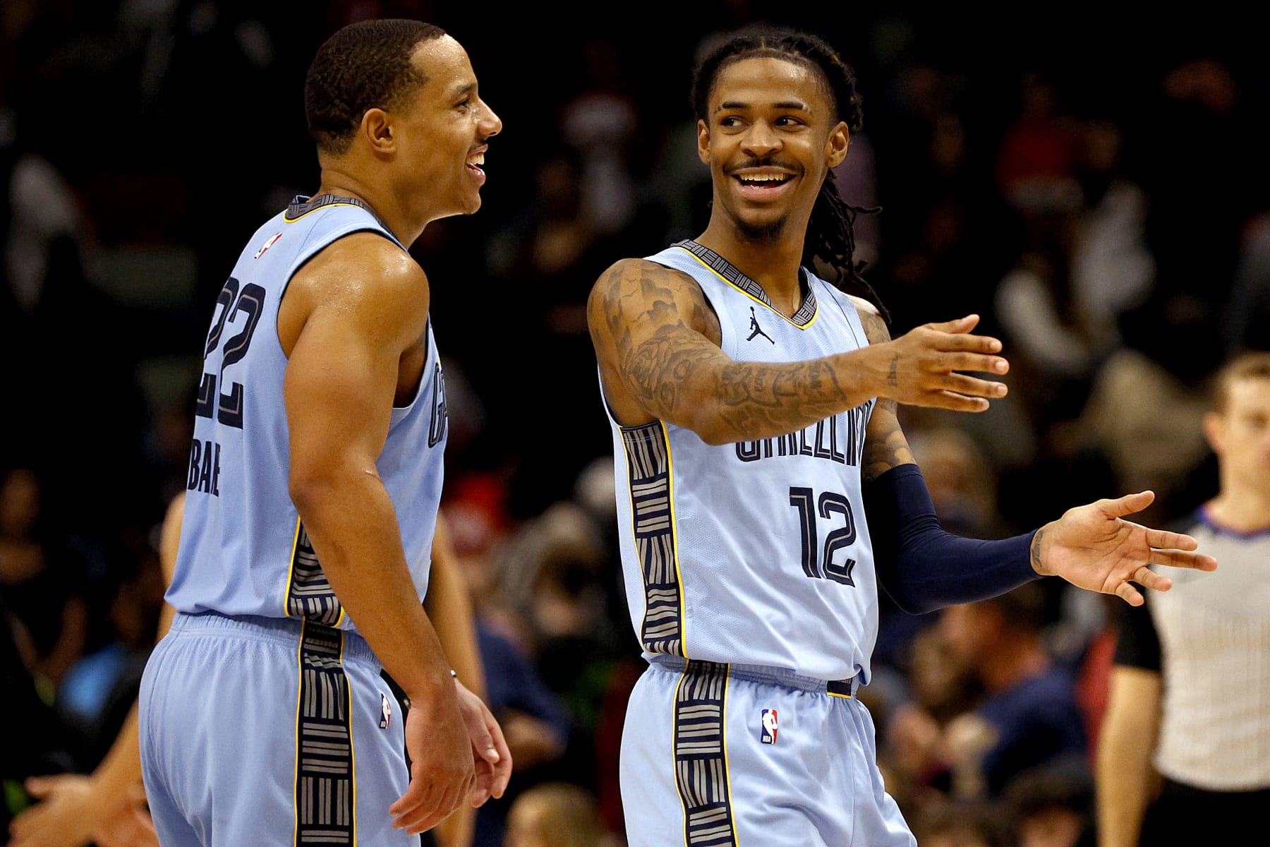NEW ORLEANS, LOUISIANA - DECEMBER 26: Ja Morant #12 of the Memphis Grizzlies reacts with Desmond Bane #22 of the Memphis Grizzlies during overtime of an NBA game against the New Orleans Pelicans at Smoothie King Center on December 26, 2023 in New Orleans, Louisiana. The Memphis Grizzlies won the game 116 - 115 over the New Orleans Pelicans. NOTE TO USER: User expressly acknowledges and agrees that, by downloading and or using this photograph, User is consenting to the terms and conditions of the Getty Images License Agreement. (Photo by Sean Gardner/Getty Images)