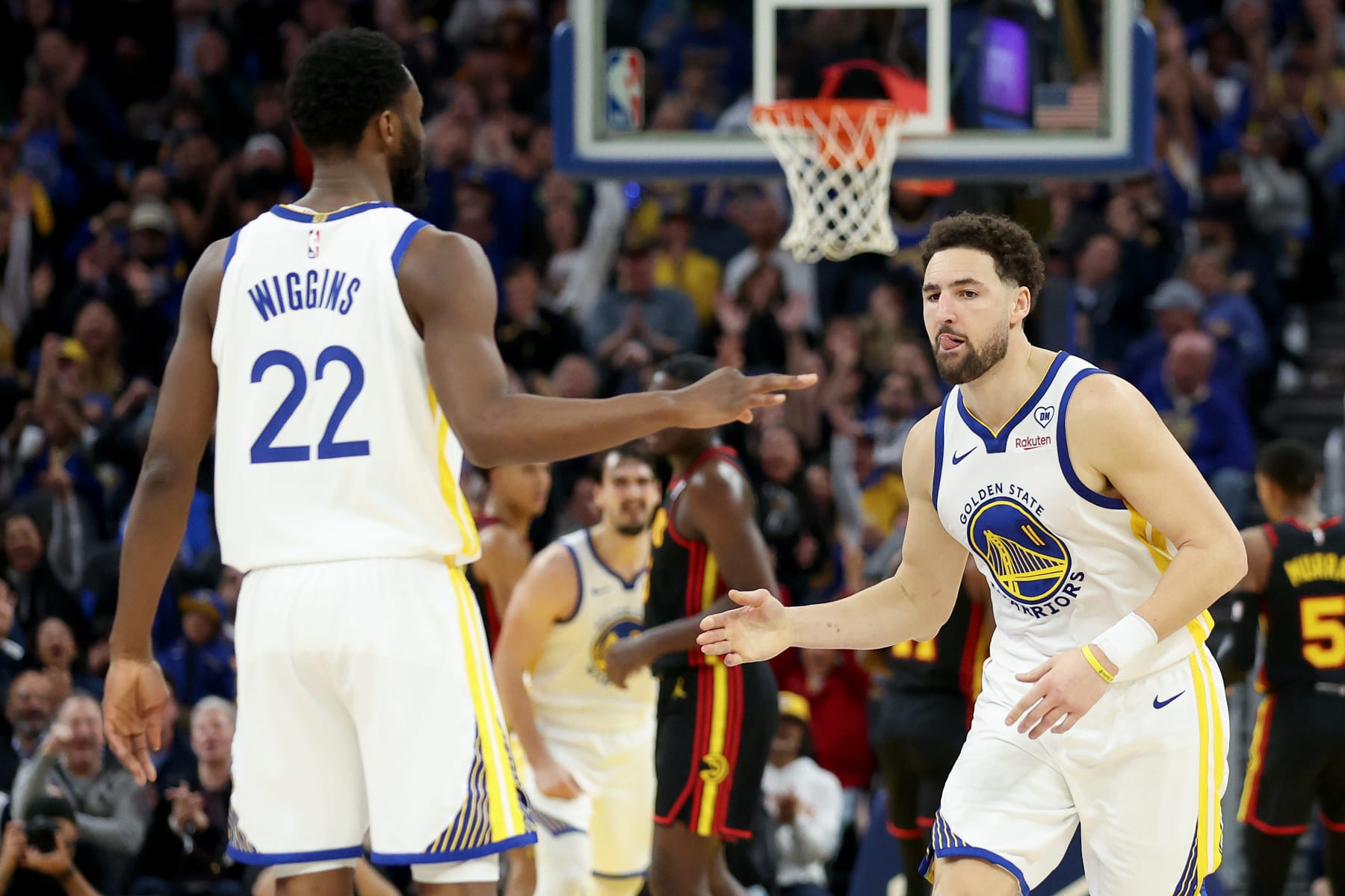 SAN FRANCISCO, CALIFORNIA - JANUARY 24: Klay Thompson #11 of the Golden State Warriors is congratulated by Andrew Wiggins #22 after he made a shot against the Atlanta Hawks in the first half at Chase Center on January 24, 2024 in San Francisco, California. NOTE TO USER: User expressly acknowledges and agrees that, by downloading and or using this photograph, User is consenting to the terms and conditions of the Getty Images License Agreement.  (Photo by Ezra Shaw/Getty Images)