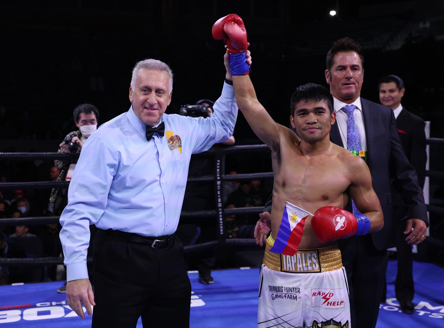 CARSON, CALIFORNIA - DECEMBER 11: Marlon Tapales has his hand lifted by referee Jack Reiss after defeating Hiroaki Teshigawara by way of knockout at Dignity Health Sports Park on December 11, 2021 in Carson, California. (Photo by Harry How/Getty Images)