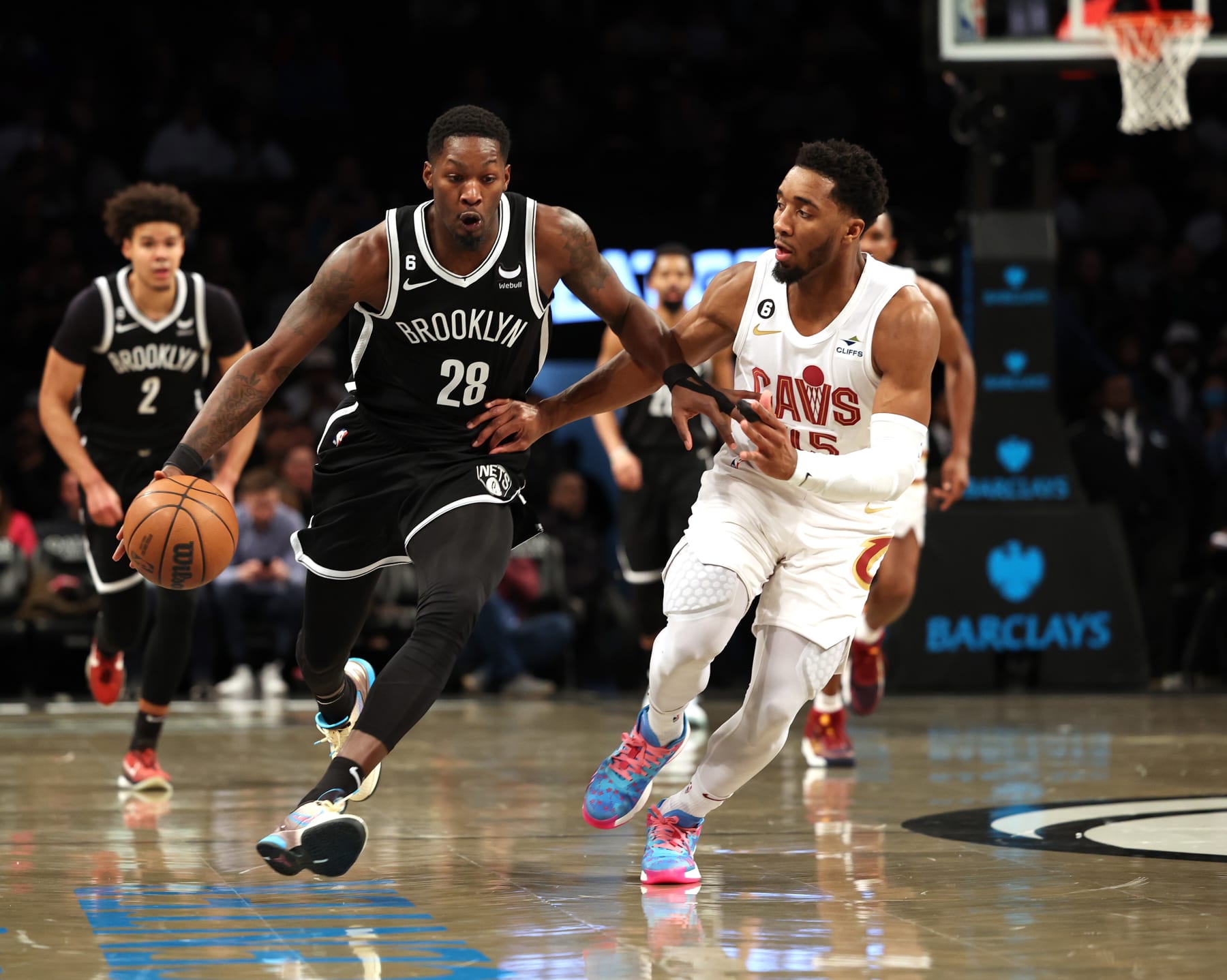 NEW YORK, NEW YORK - MARCH 21:   Dorian Finney-Smith #28 of the Brooklyn Nets dribbles against Donovan Mitchell #45 of the Cleveland Cavaliers during their game at Barclays Center on March 21, 2023 in New York City.  User expressly acknowledges and agrees that, by downloading and or using this photograph, User is consenting to the terms and conditions of the Getty Images License Agreement.  (Photo by Al Bello/Getty Images)