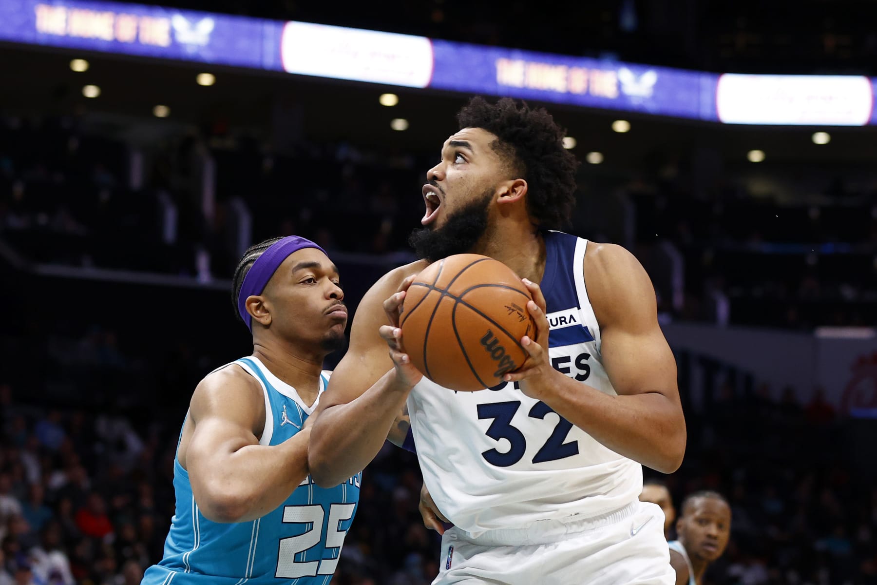 CHARLOTTE, NORTH CAROLINA - NOVEMBER 26: Karl-Anthony Towns #32 of the Minnesota Timberwolves posts up against P.J. Washington #25 of the Charlotte Hornets during the second half of the game at Spectrum Center on November 26, 2021 in Charlotte, North Carolina. NOTE TO USER: User expressly acknowledges and agrees that, by downloading and or using this photograph, User is consenting to the terms and conditions of the Getty Images License Agreement. (Photo by Jared C. Tilton/Getty Images)