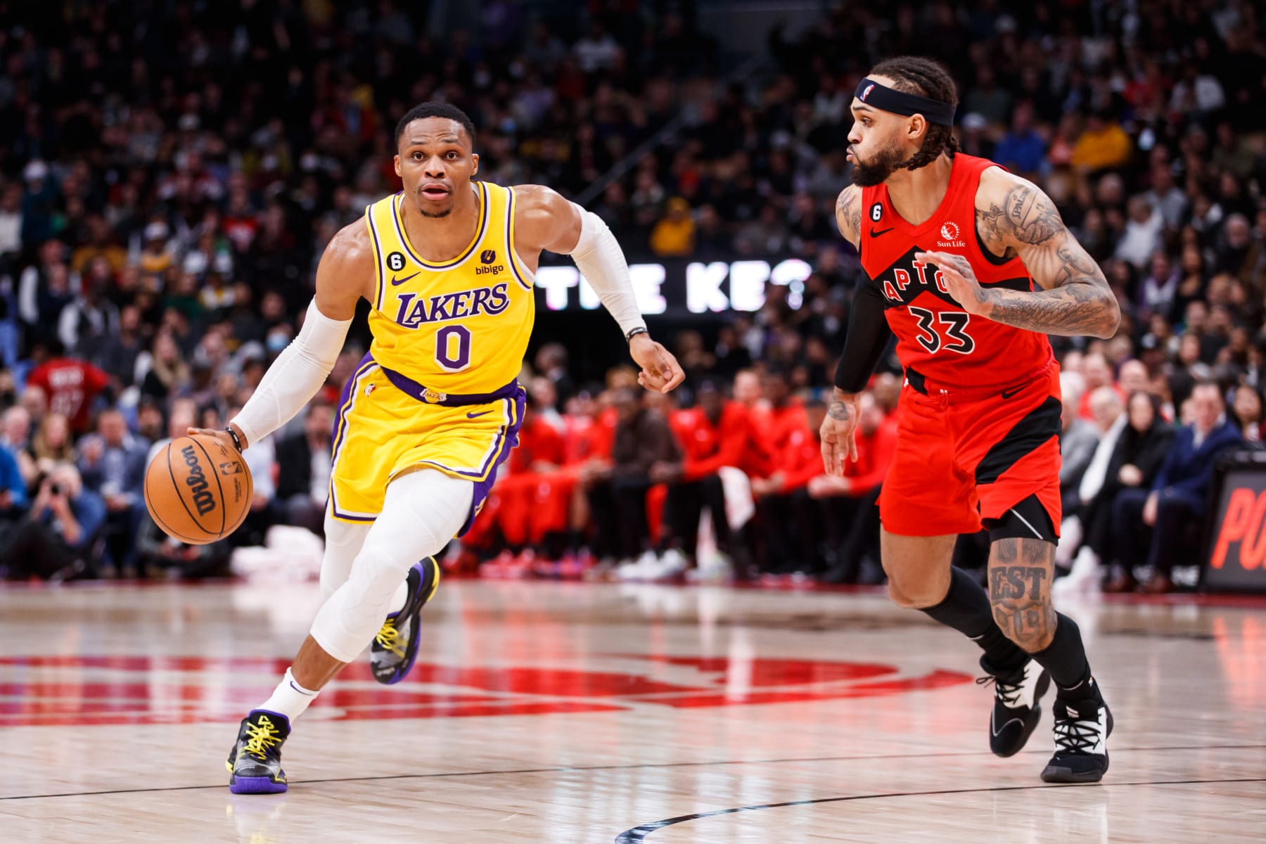 TORONTO, ON - DECEMBER 07: Russell Westbrook #0 of the Los Angeles Lakers dribbles against Gary Trent Jr. #33 of the Toronto Raptors during the second half of their NBA game at Scotiabank Arena on December 7, 2022 in Toronto, Canada. NOTE TO USER: User expressly acknowledges and agrees that, by downloading and or using this photograph, User is consenting to the terms and conditions of the Getty Images License Agreement. (Photo by Cole Burston/Getty Images)