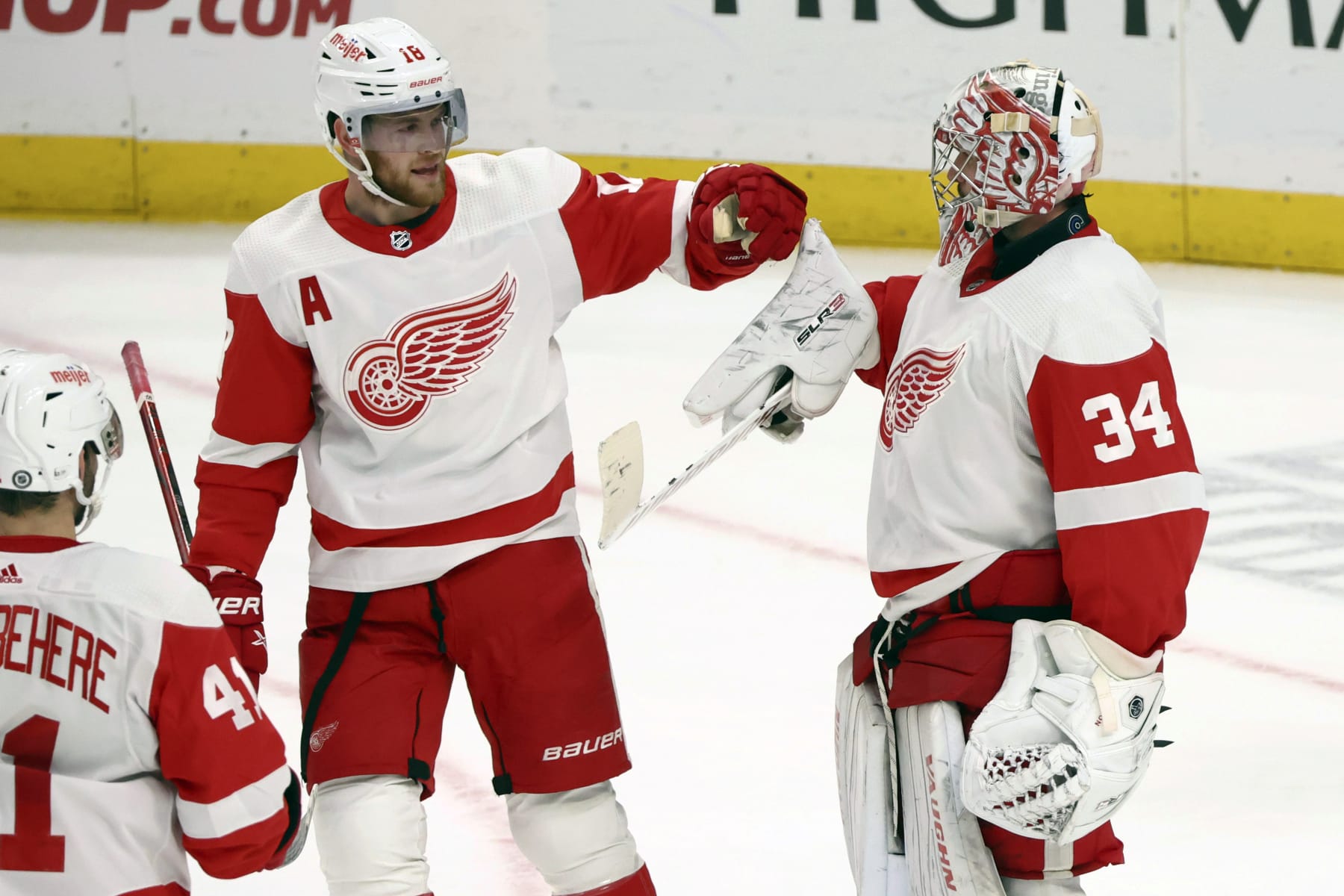 Detroit Red Wings goaltender Alex Lyon (34) celebrates a 5-3 victory with center Andrew Copp (18) following the third period of an NHL hockey game against the Buffalo Sabres Tuesday, Dec. 5, 2023, in Buffalo, N.Y. (AP Photo/Jeffrey T. Barnes)