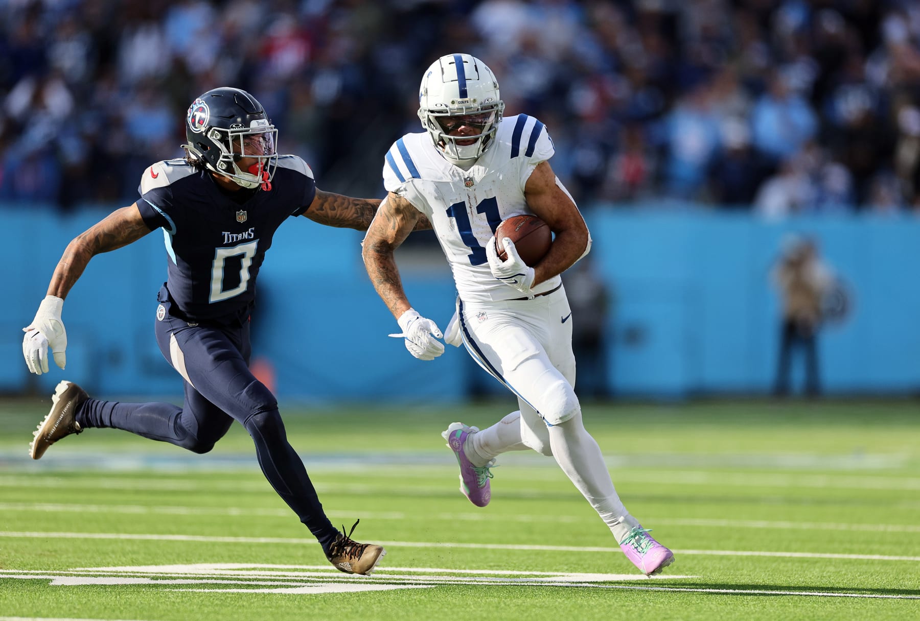 NASHVILLE, TENNESSEE - DECEMBER 03: Michael Pittman Jr. #11 of the Indianapolis Colts carries the ball past Sean Murphy-Bunting #0 of the Tennessee Titans during the second half at Nissan Stadium on December 03, 2023 in Nashville, Tennessee. (Photo by Andy Lyons/Getty Images)