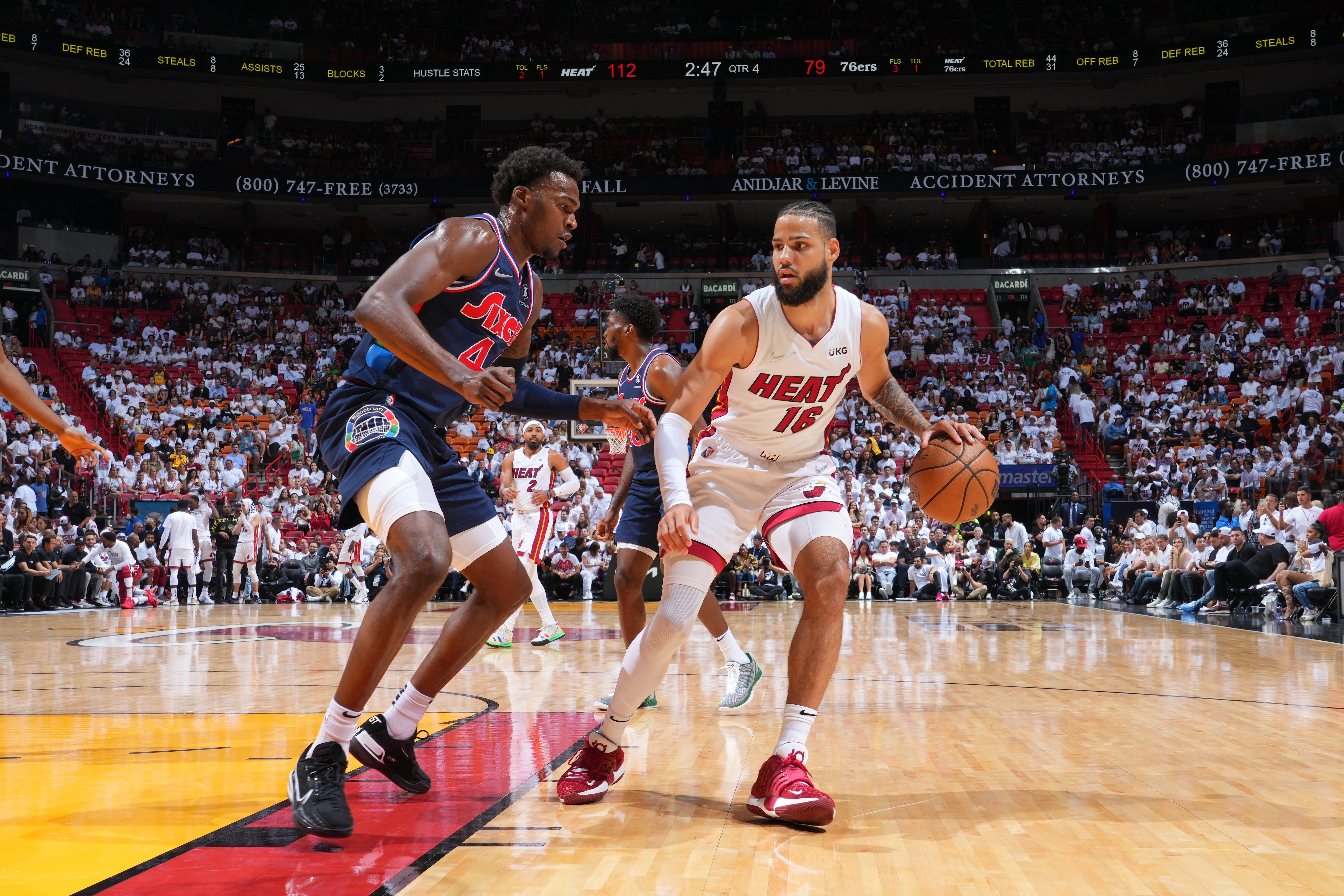 MIAMI, FL - MAY 10: Caleb Martin #16 of the Miami Heat handles the ball against Paul Reed #44 of the Philadelphia 76ers during Game 5 of the 2022 NBA Playoffs Eastern Conference Semifinals on May 10, 2022 at The FTX Arena in Miami, Florida. NOTE TO USER: User expressly acknowledges and agrees that, by downloading and/or using this Photograph, user is consenting to the terms and conditions of the Getty Images License Agreement. Mandatory Copyright Notice: Copyright 2022 NBAE (Photo by Jesse D. Garrabrant/NBAE via Getty Images)