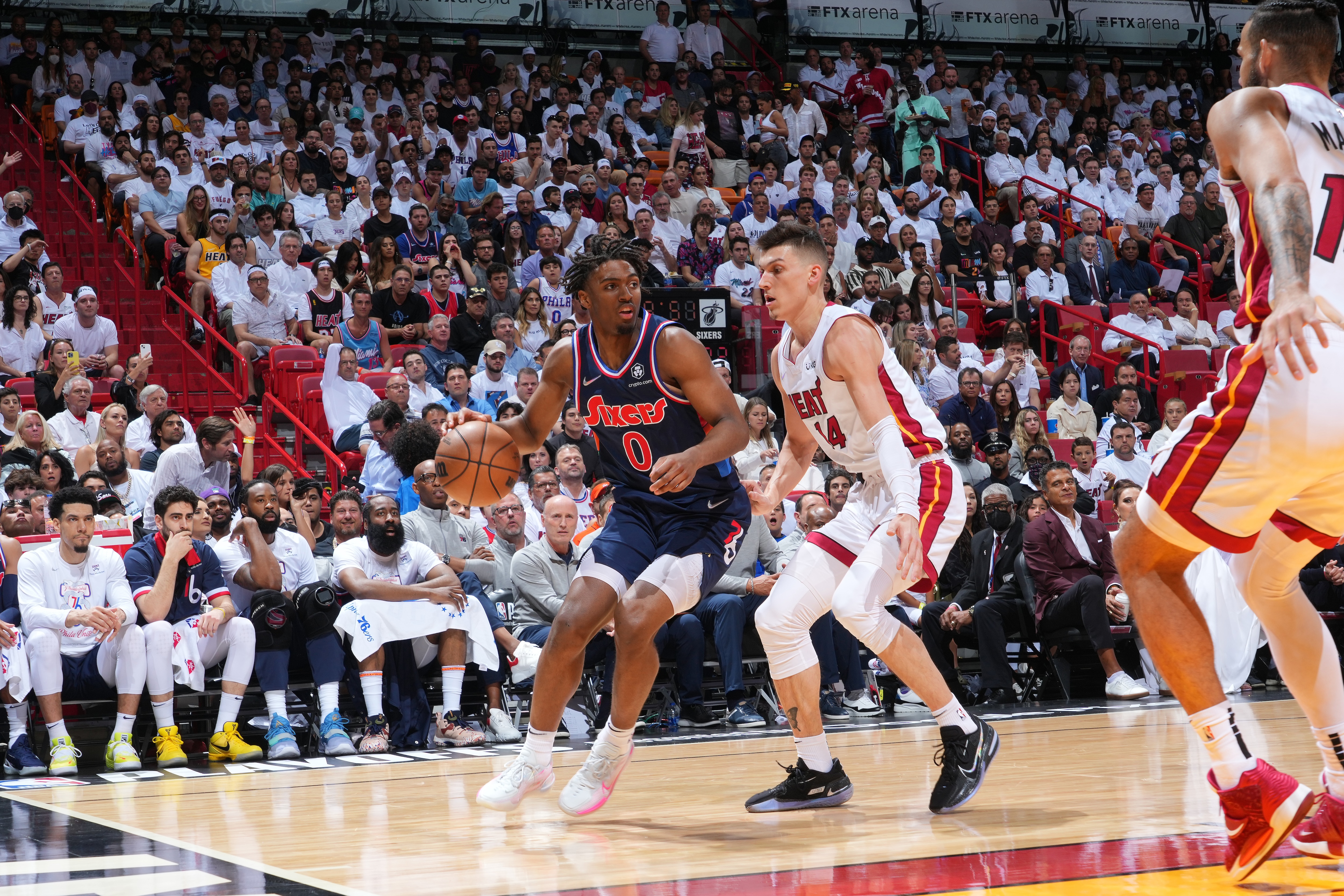 MIAMI, FL - MAY 10: Tyrese Maxey #0 of the Philadelphia 76ers handles the ball against Tyler Herro #14 of the Miami Heat during Game 5 of the 2022 NBA Playoffs Eastern Conference Semifinals on May 10, 2022 at The FTX Arena in Miami, Florida. NOTE TO USER: User expressly acknowledges and agrees that, by downloading and/or using this Photograph, user is consenting to the terms and conditions of the Getty Images License Agreement. Mandatory Copyright Notice: Copyright 2022 NBAE (Photo by Jesse D. Garrabrant/NBAE via Getty Images)