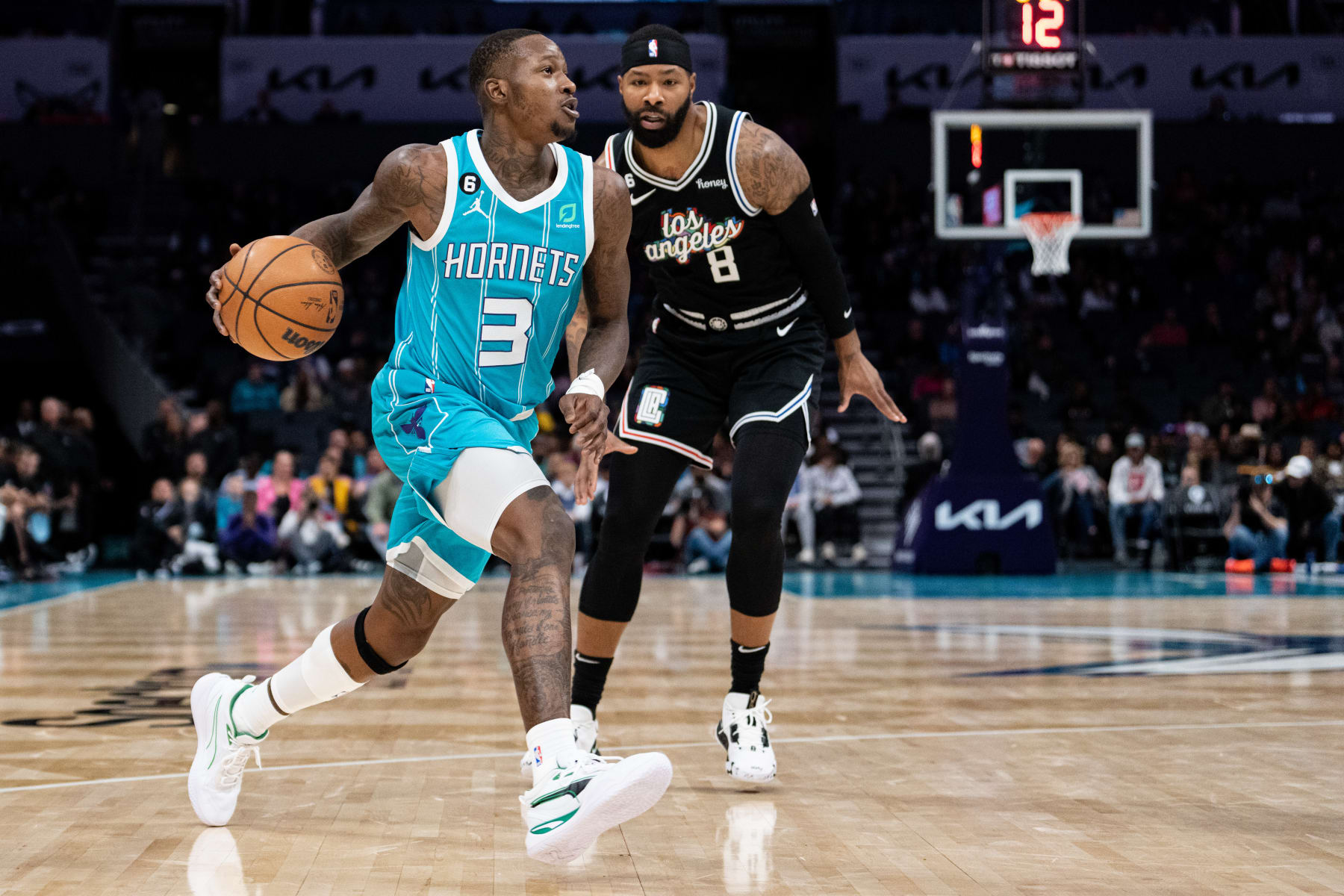CHARLOTTE, NORTH CAROLINA - DECEMBER 05: Terry Rozier #3 of the Charlotte Hornets drives to the basket while guarded by Marcus Morris Sr. #8 of the LA Clippers during their game at Spectrum Center on December 05, 2022 in Charlotte, North Carolina. NOTE TO USER: User expressly acknowledges and agrees that, by downloading and or using this photograph, User is consenting to the terms and conditions of the Getty Images License Agreement. (Photo by Jacob Kupferman/Getty Images)
