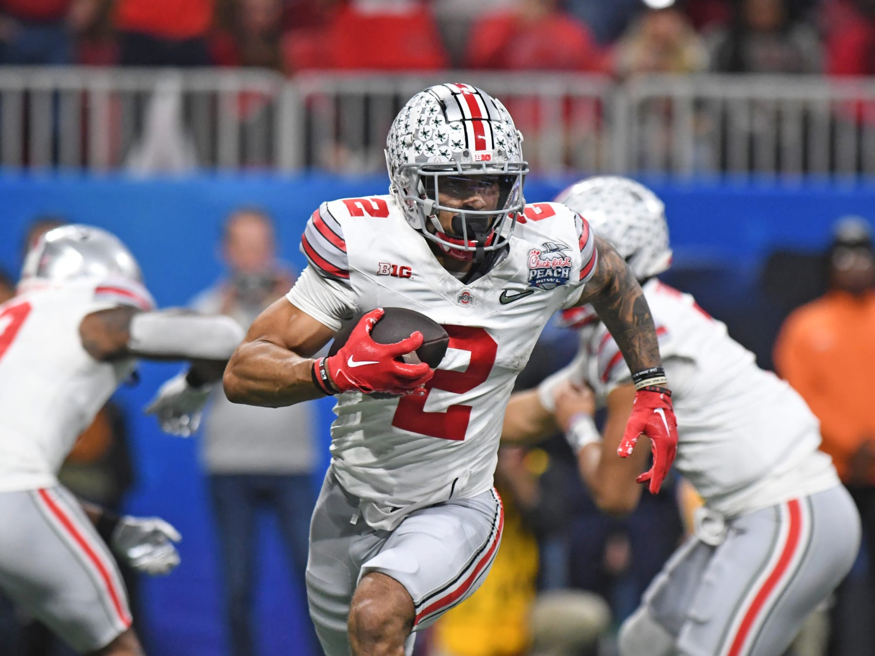ATLANTA, GA - DECEMBER 31: Ohio State Buckeyes Wide Receiver Emeka Egbuka (2) rushes the ball during the Chick-fil-A Peach Bowl College Football Playoff Semifinal game between the Georgia Bulldogs and the Ohio State Buckeyes on December 31, 2022, at Mercedes-Benz Stadium in Atlanta, GA. (Photo by Jeffrey Vest/Icon Sportswire via Getty Images)
