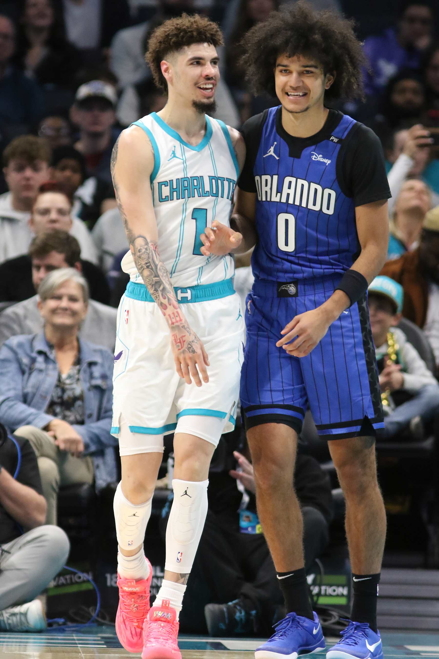 CHARLOTTE, NC -NOVEMBER 25:  LaMelo Ball #1 of the Charlotte Hornets and Anthony Black #0 of the Orlando Magic smile during the game on November 25, 2024 at Spectrum Center in Charlotte, North Carolina. NOTE TO USER: User expressly acknowledges and agrees that, by downloading and or using this photograph, User is consenting to the terms and conditions of the Getty Images License Agreement. Mandatory Copyright Notice: Copyright 2024 NBAE (Photo by Brock Williams-Smith/NBAE via Getty Images)