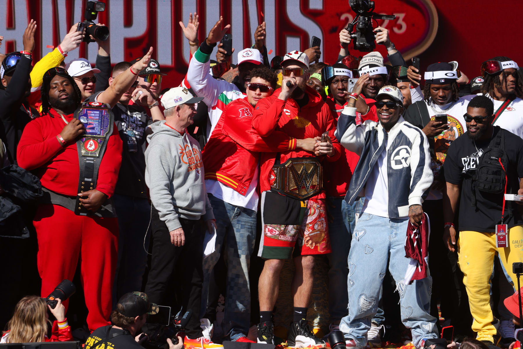KANSAS CITY, MISSOURI - FEBRUARY 14: Patrick Mahomes #15  and Travis Kelce #87 of the Kansas City Chiefs celebrate on stage with teammates during the Kansas City Chiefs Super Bowl LVIII victory parade on February 14, 2024 in Kansas City, Missouri. (Photo by Jamie Squire/Getty Images)