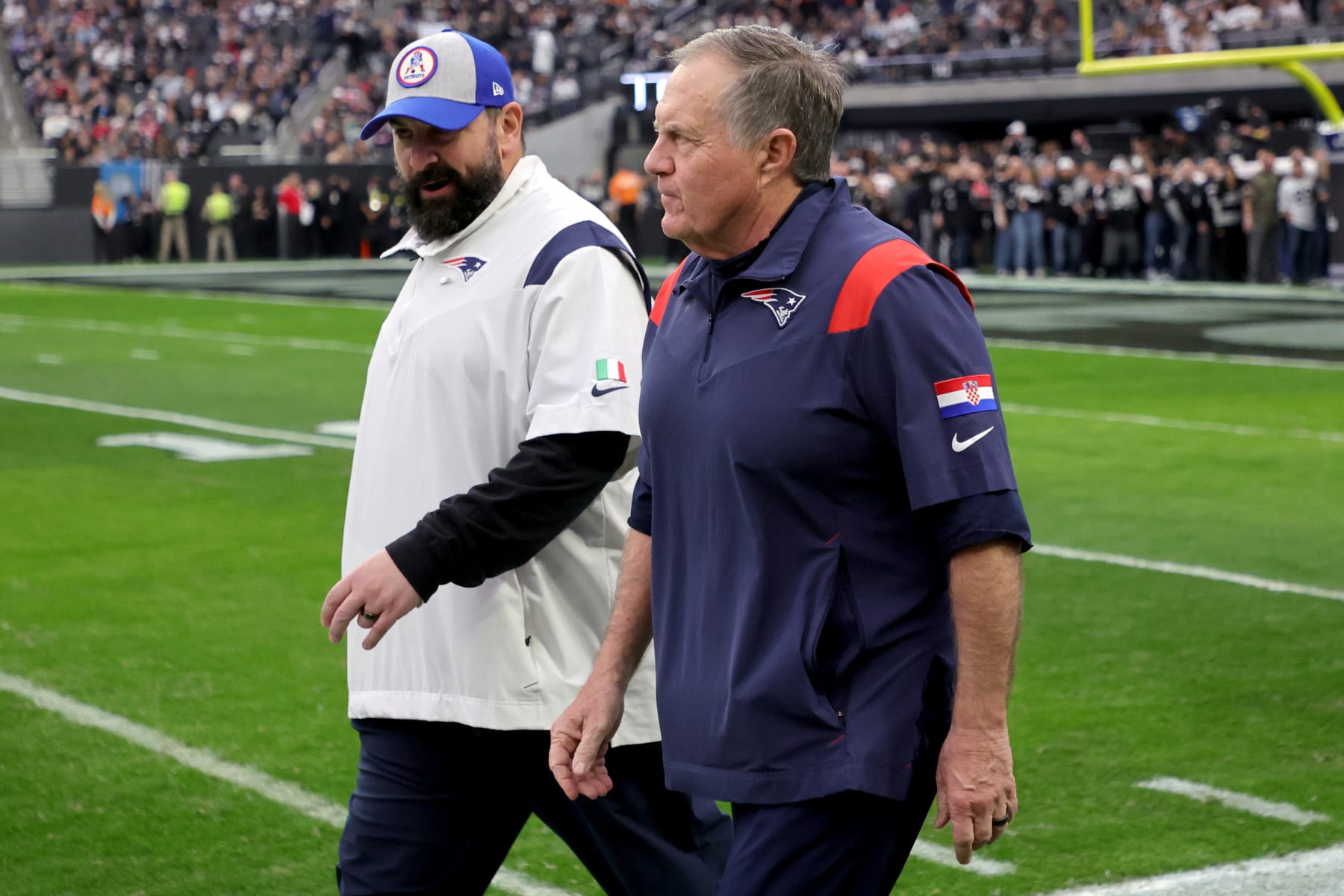 LAS VEGAS, NEVADA - DECEMBER 18: Senior football advisor and offensive line coach Matt Patricia (L) and head coach Bill Belichick of the New England Patriots walk onto the field for a game against the Las Vegas Raiders at Allegiant Stadium on December 18, 2022 in Las Vegas, Nevada. (Photo by Ethan Miller/Getty Images)