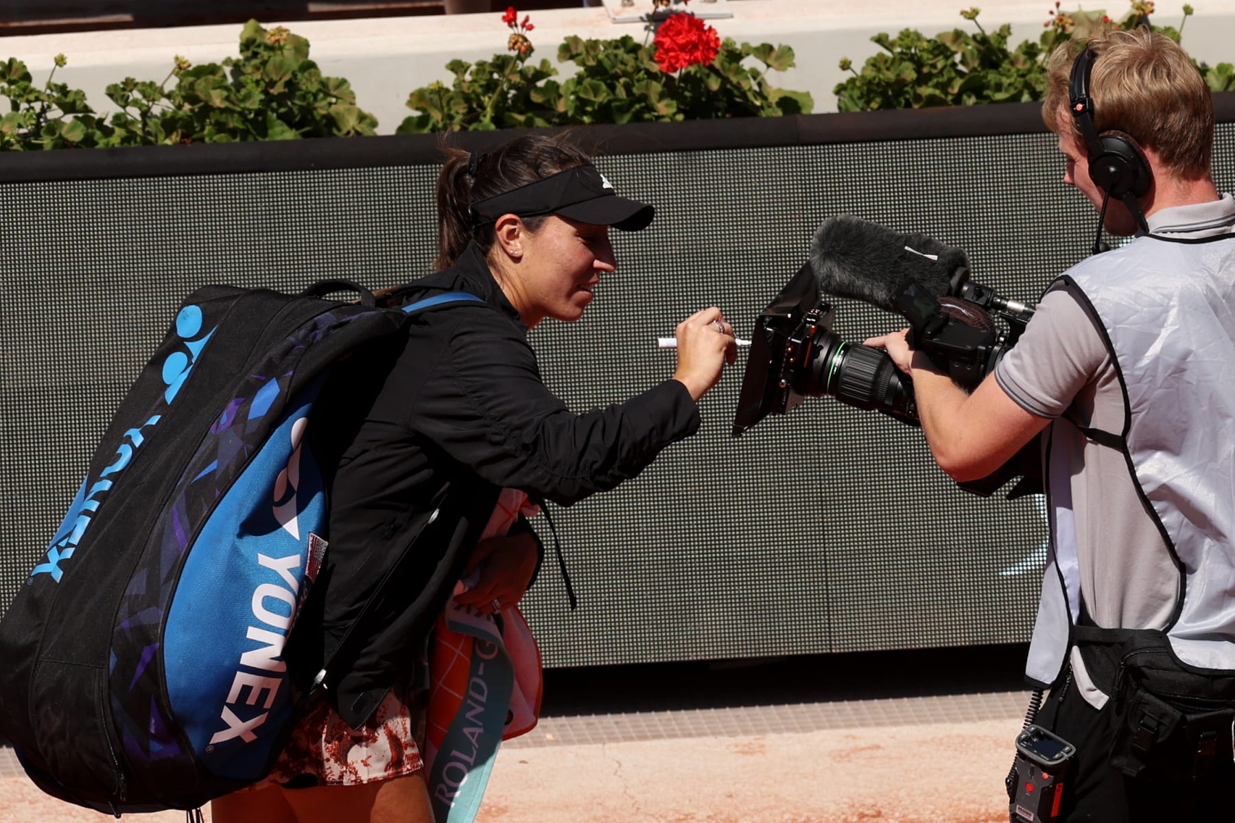 PARIS, FRANCE - MAY 31: Jessica Pegula of United States signs a TV camera after Camila Giorgi of Italy retired in the Women's Second Round Match on Day Four of the 2023 French Open at Roland Garros on May 31, 2023 in Paris, France. (Photo by Clive Brunskill/Getty Images)