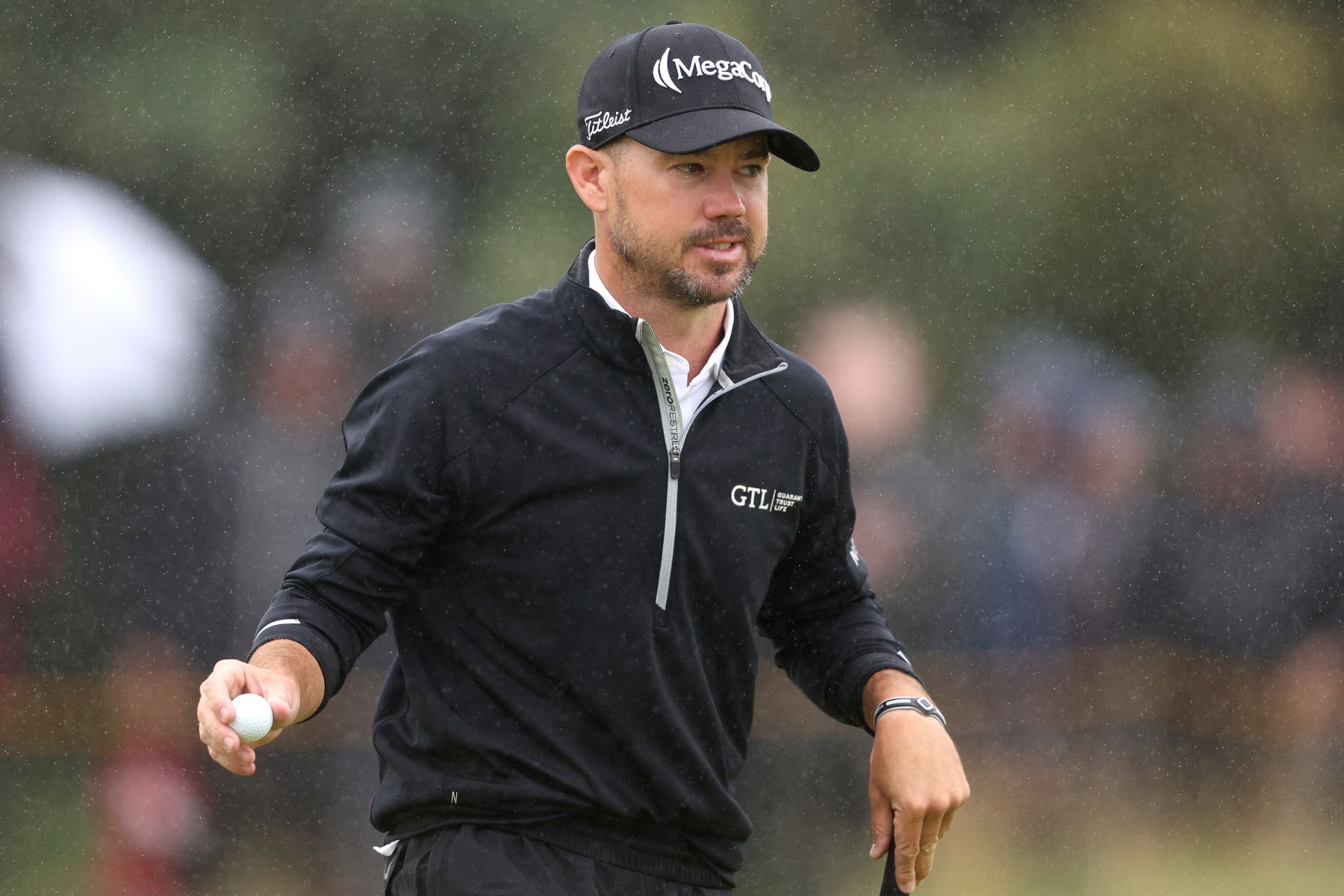 HOYLAKE, ENGLAND - JULY 23: Brian Harman of the United States raises their ball after putting on the 8th green on Day Four of The 151st Open at Royal Liverpool Golf Club on July 23, 2023 in Hoylake, England. (Photo by Warren Little/Getty Images)