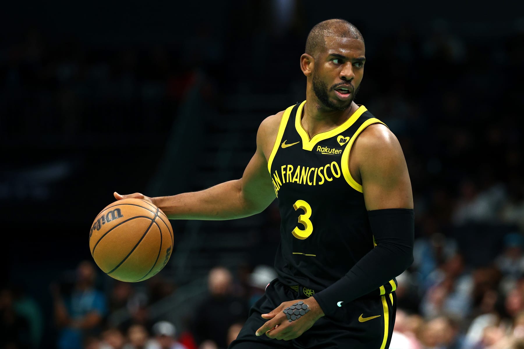 CHARLOTTE, NORTH CAROLINA - MARCH 29: Chris Paul #3 of the Golden State Warriors brings the ball up court during the first half of the game against the Charlotte Hornets at Spectrum Center on March 29, 2024 in Charlotte, North Carolina. NOTE TO USER: User expressly acknowledges and agrees that, by downloading and or using this photograph, User is consenting to the terms and conditions of the Getty Images License Agreement. (Photo by Jared C. Tilton/Getty Images)