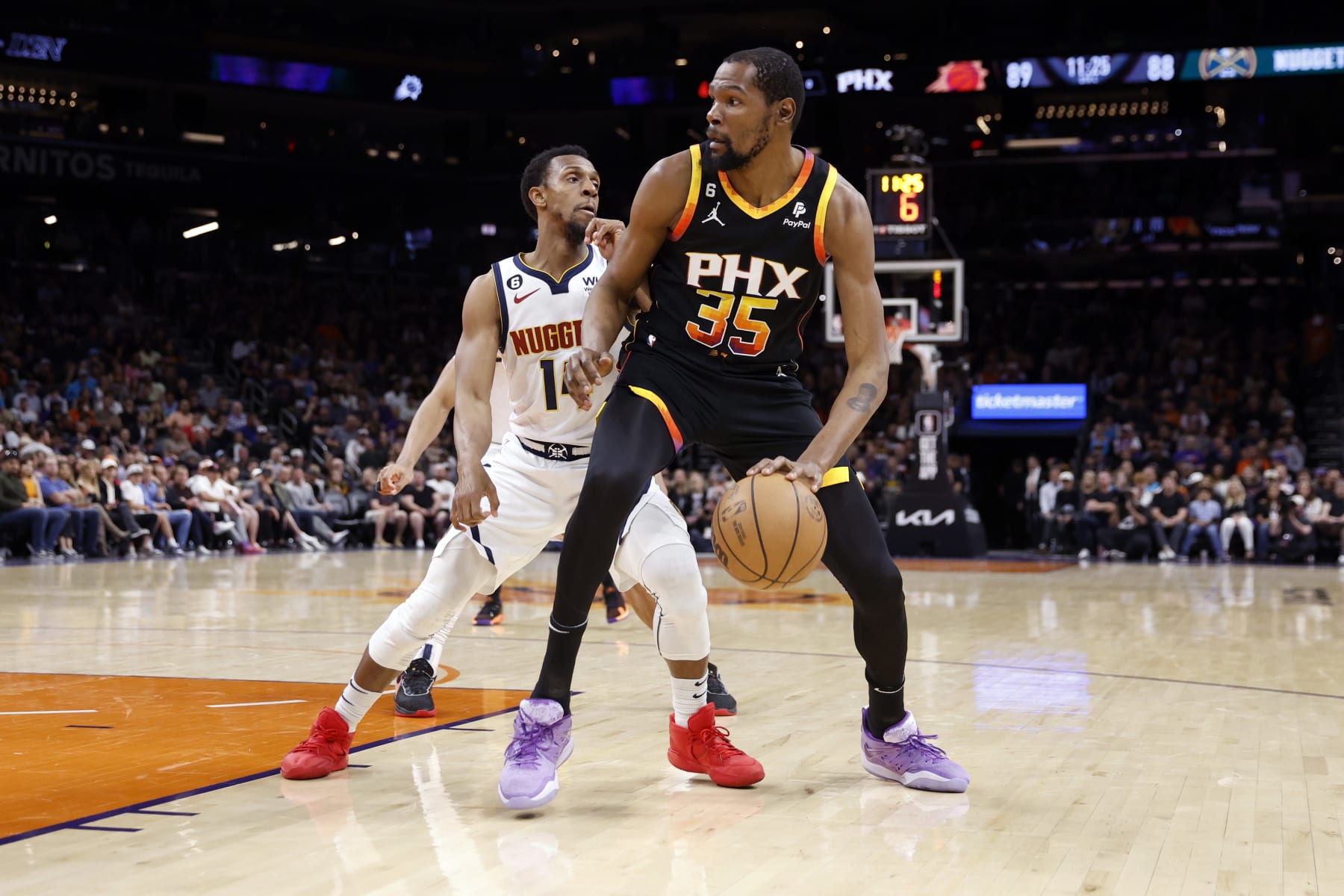 PHOENIX, ARIZONA - APRIL 06: Kevin Durant #35 of the Phoenix Suns posts up on Ish Smith #14 of the Denver Nuggets during the game at Footprint Center on April 06, 2023 in Phoenix, Arizona. The Suns beat the Nuggets 119-115. NOTE TO USER: User expressly acknowledges and agrees that, by downloading and or using this photograph, User is consenting to the terms and conditions of the Getty Images License Agreement.  (Photo by Chris Coduto/Getty Images)