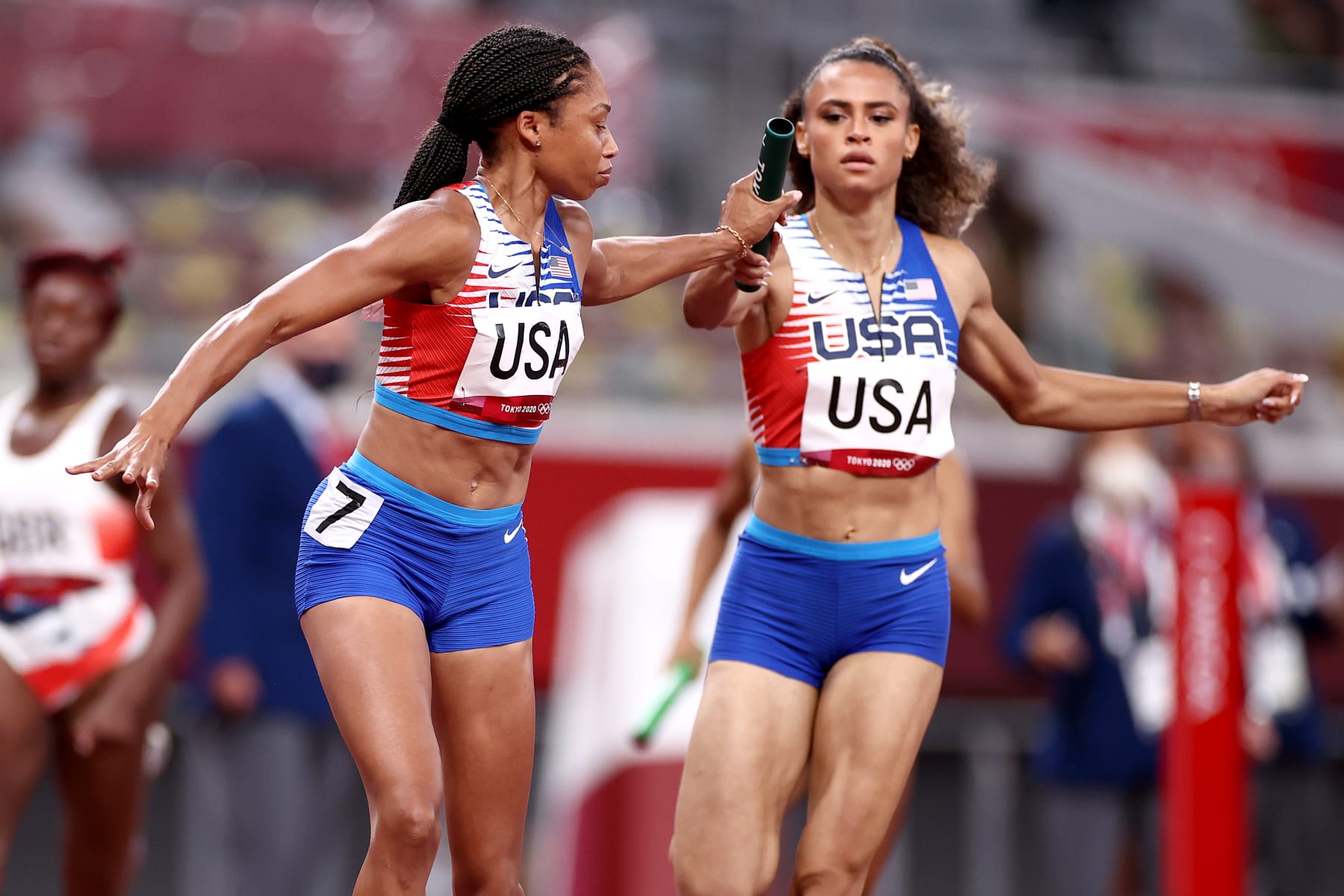 TOKYO, JAPAN - AUGUST 07:  Allyson Felix of Team United States takes the baton from Sydney McLaughlin in the Women's 4 x 400m Relay Final on day fifteen of the Tokyo 2020 Olympic Games at Olympic Stadium on August 07, 2021 in Tokyo, Japan. (Photo by Ryan Pierse/Getty Images)