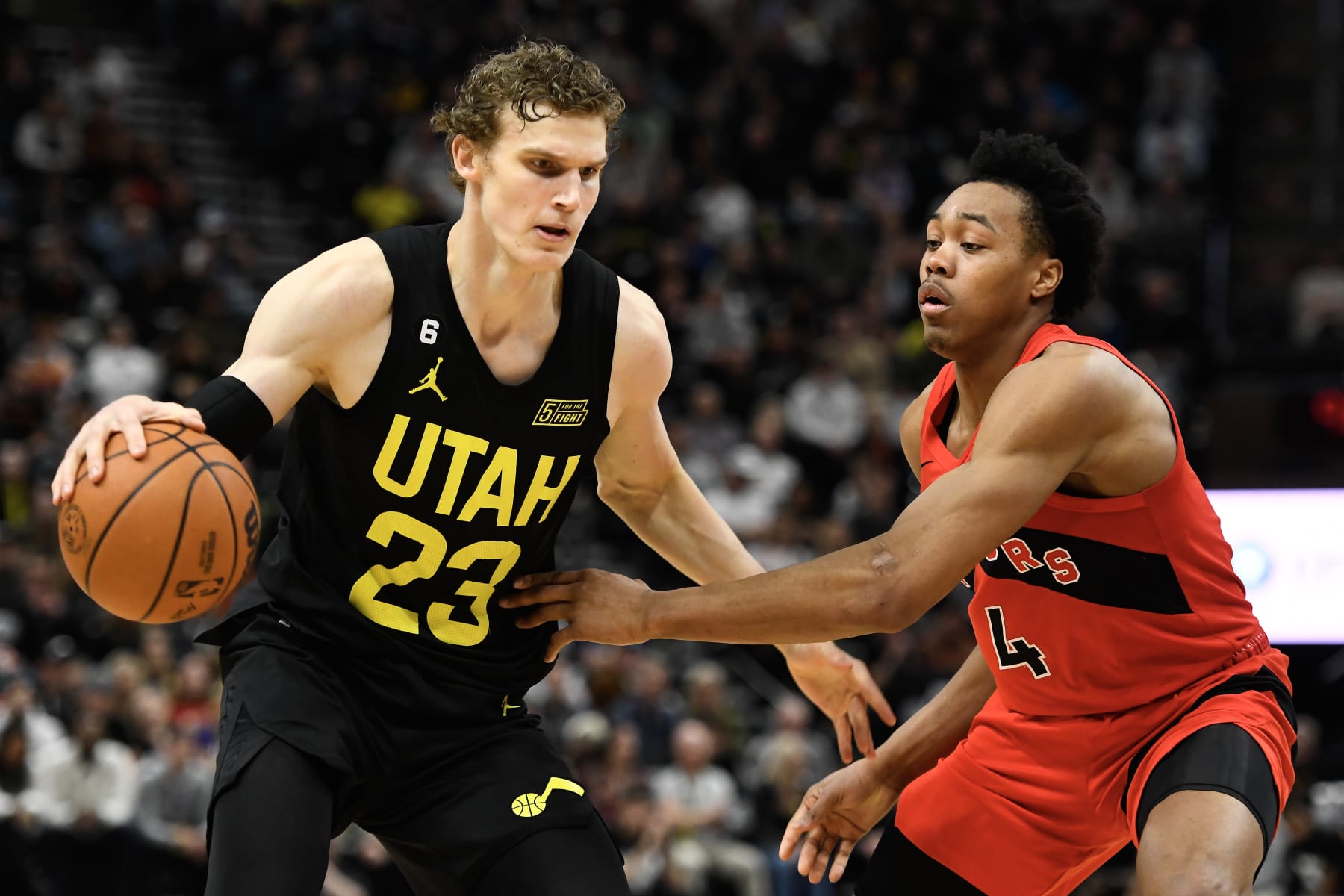 SALT LAKE CITY, UTAH - FEBRUARY 01: Scottie Barnes #4 of the Toronto Raptors defends Lauri Markkanen #23 of the Utah Jazz during the second half of a game at Vivint Arena on February 01, 2023 in Salt Lake City, Utah. NOTE TO USER: User expressly acknowledges and agrees that, by downloading and or using this photograph, User is consenting to the terms and conditions of the Getty Images License Agreement.  (Photo by Alex Goodlett/Getty Images)