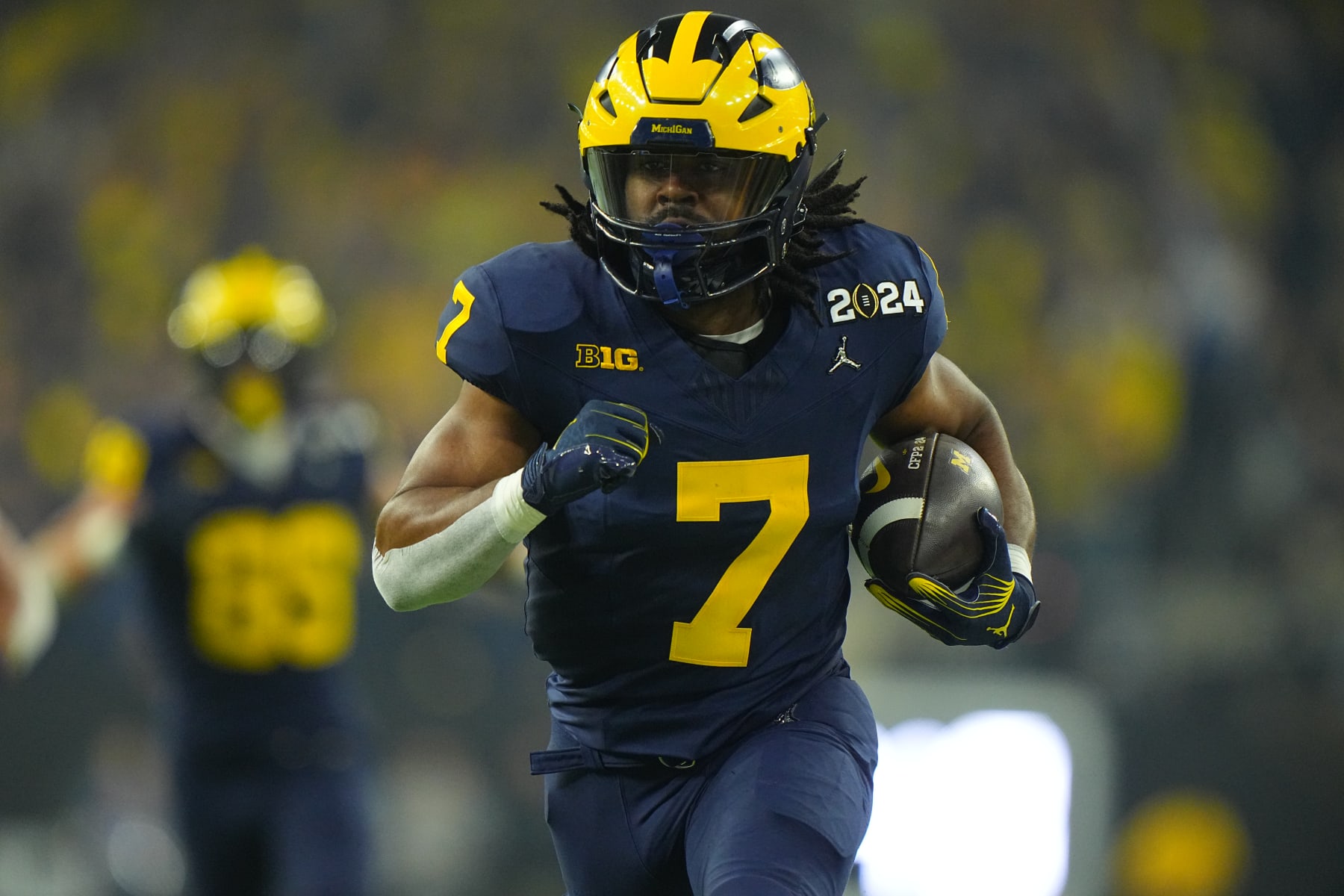 College Football: CFP National Championship: Michigan Donovan Edwards (7) in action, runs with the football vs Washington at NRG Stadium. 
Houston, TX 1/8/2024
CREDIT: Erick W. Rasco (Photo by Erick W. Rasco/Sports Illustrated via Getty Images) 
(Set Number: X164476 TK1)