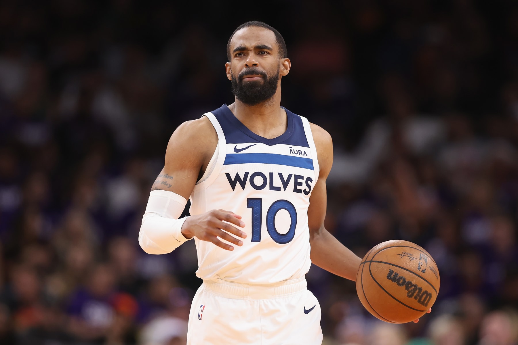 PHOENIX, ARIZONA - APRIL 28: Mike Conley #10 of the Minnesota Timberwolves handles the ball during the second half of game four of the Western Conference First Round Playoffs at Footprint Center on April 28, 2024 in Phoenix, Arizona. The Timberwolves defeated the Suns 122-116 and win the series 4-0.  NOTE TO USER: User expressly acknowledges and agrees that, by downloading and or using this photograph, User is consenting to the terms and conditions of the Getty Images License Agreement.  (Photo by Christian Petersen/Getty Images)