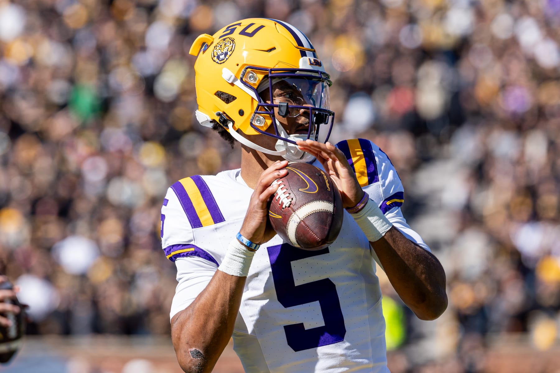 COLUMBIA, MISSOURI - OCTOBER 7: Jayden Daniels #5 of the LSU Tigers warms up during a timeout against the Missouri Tigers at Faurot Field/Memorial Stadium on October 7, 2023 in Columbia, Missouri. (Photo by Michael Hickey/Getty Images)