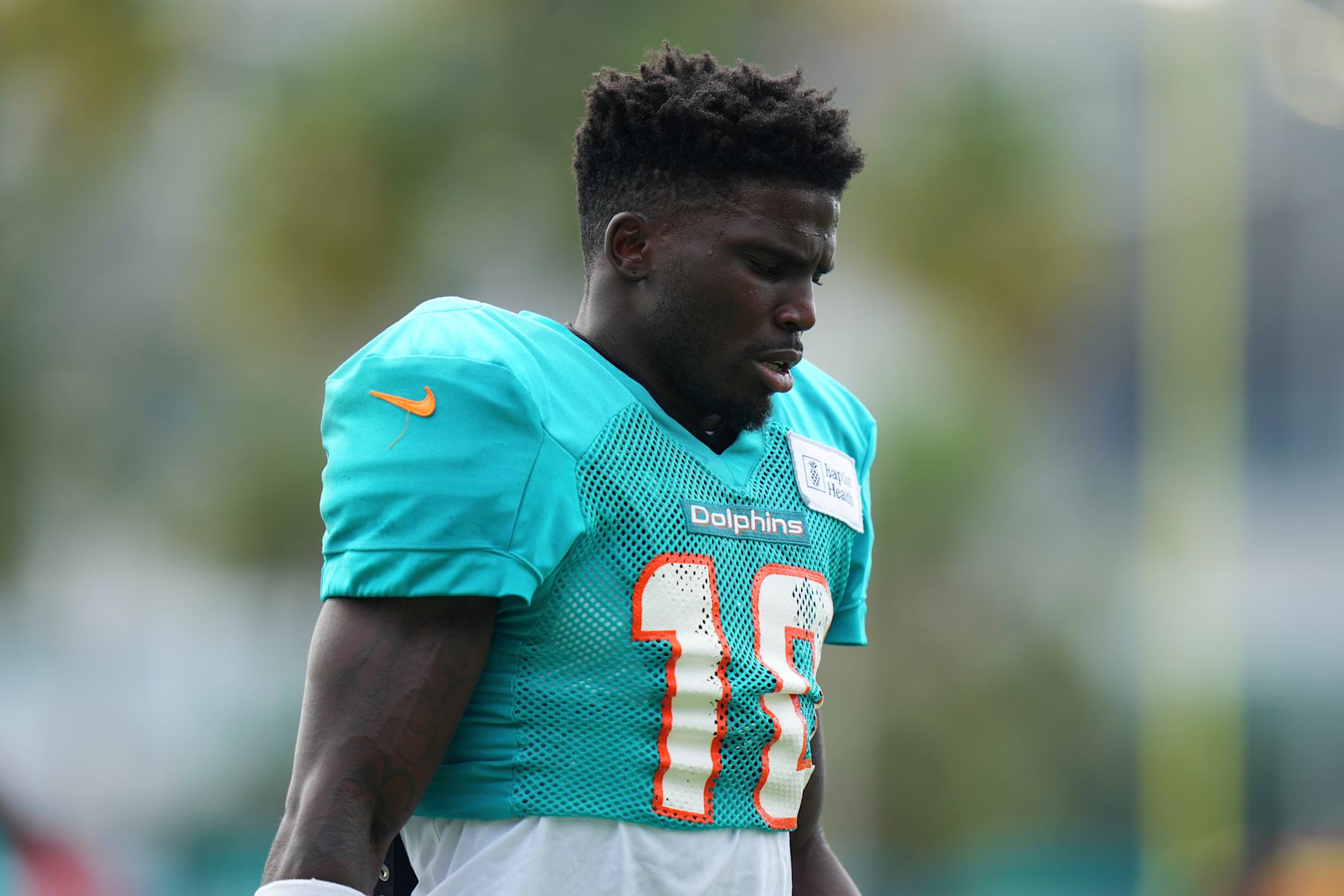 MIAMI GARDENS, FLORIDA - AUGUST 07: Tyreek Hill #10 of the Miami Dolphins looks on during training camp practice with the Atlanta Falcons on August 07, 2024 in Miami Gardens, Florida. (Photo by Rich Storry/Getty Images)