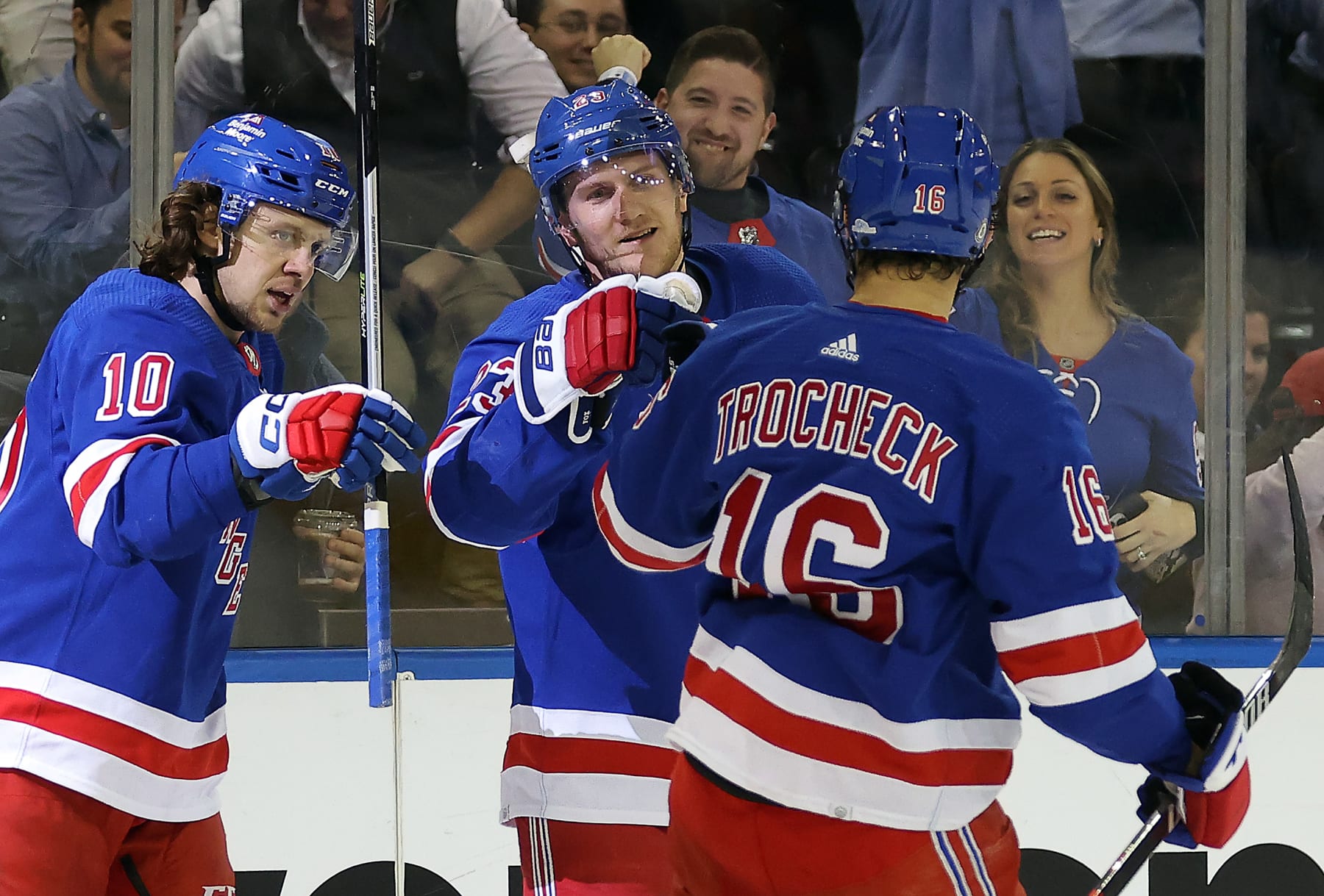NEW YORK, NEW YORK - JANUARY 10:  Adam Fox #23 of the New York Rangers is congratulated by teammates after scoring during the game against the Minnesota Wild at Madison Square Garden on January 10, 2023 in New York City. (Photo by Jamie Squire/Getty Images)