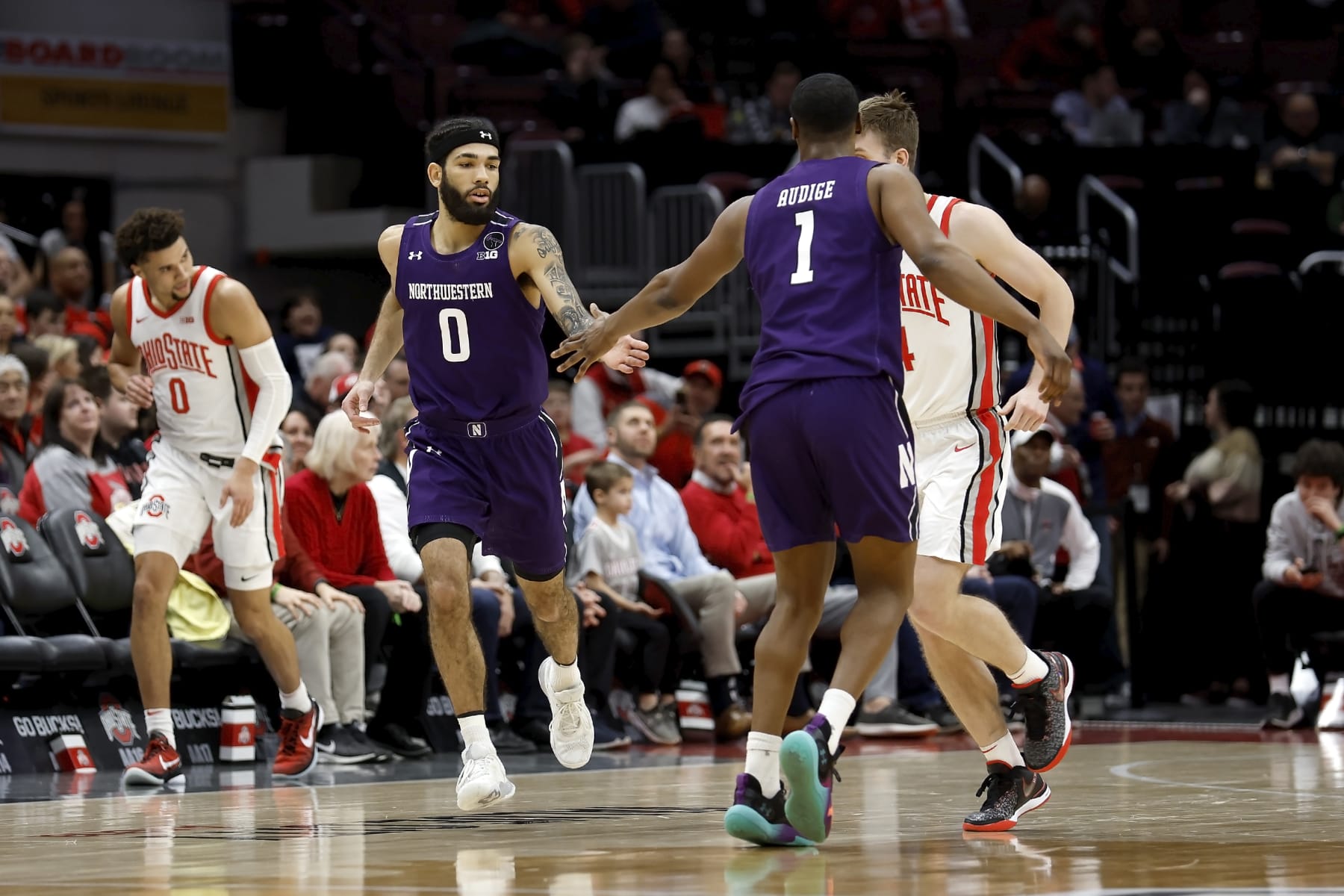COLUMBUS, OH - FEBRUARY 09:  Boo Buie #0 of the Northwestern Wildcats is congratulated by Chase Audige #1 after making a shot during the game against the Ohio State Buckeyes at the Jerome Schottenstein Center on February 9, 2023 in Columbus, Ohio. (Photo by Kirk Irwin/Getty Images)