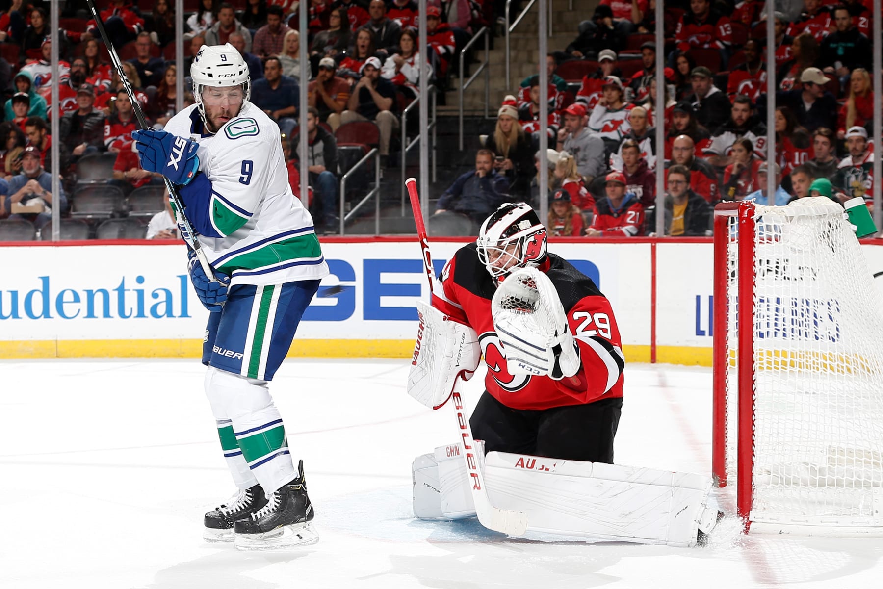 NEWARK, NJ - OCTOBER 19:  Mackenzie Blackwood #29 of the New Jersey Devils tends the net as J.T. Miller #9 of the Vancouver Canucks sets a screen at the Prudential Center on October 19, 2019 in Newark, New Jersey. (Photo by Andy Marlin/NHLI via Getty Images)