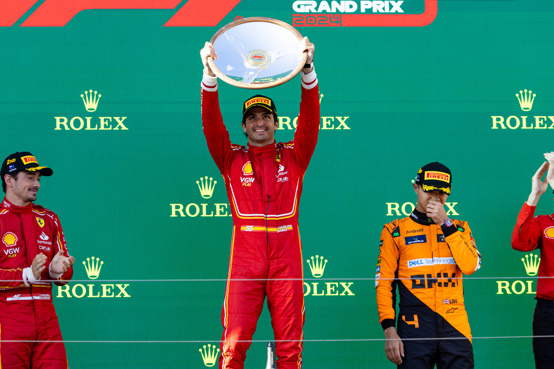 MELBOURNE, AUSTRALIA - MARCH 24: Carlos Sainz of Spain and Scuderia Ferrari, Lando Norris of Great Britain and McLaren F1 and Charles Leclerc of Monaco and Scuderia Ferrari on the podium after the F1 Grand Prix of Australia at Albert Park Circuit on March 24, 2024 in Melbourne, Australia. (Photo by Kym Illman/Getty Images)