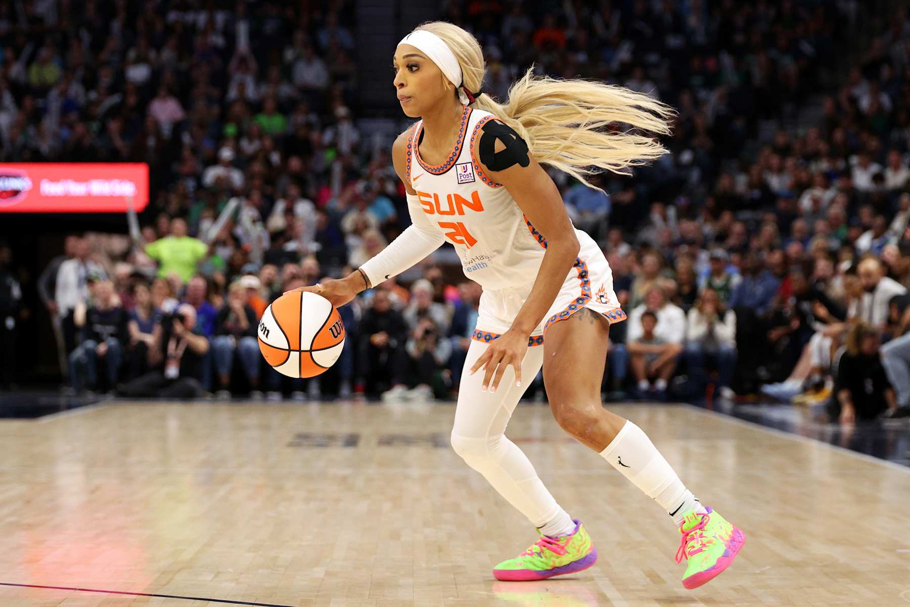 MINNEAPOLIS, MINNESOTA - OCTOBER 08: DiJonai Carrington #21 of the Connecticut Sun dribbles the ball against the Minnesota Lynx in the fourth quarter of Game Five of the Semi-Finals during the WNBA Playoffs at Target Center on October 08, 2024 in Minneapolis, Minnesota. The Lynx defeated the Sun 88-77. NOTE TO USER: User expressly acknowledges and agrees that, by downloading and or using this photograph, User is consenting to the terms and conditions of the Getty Images License Agreement. (Photo by David Berding/Getty Images)