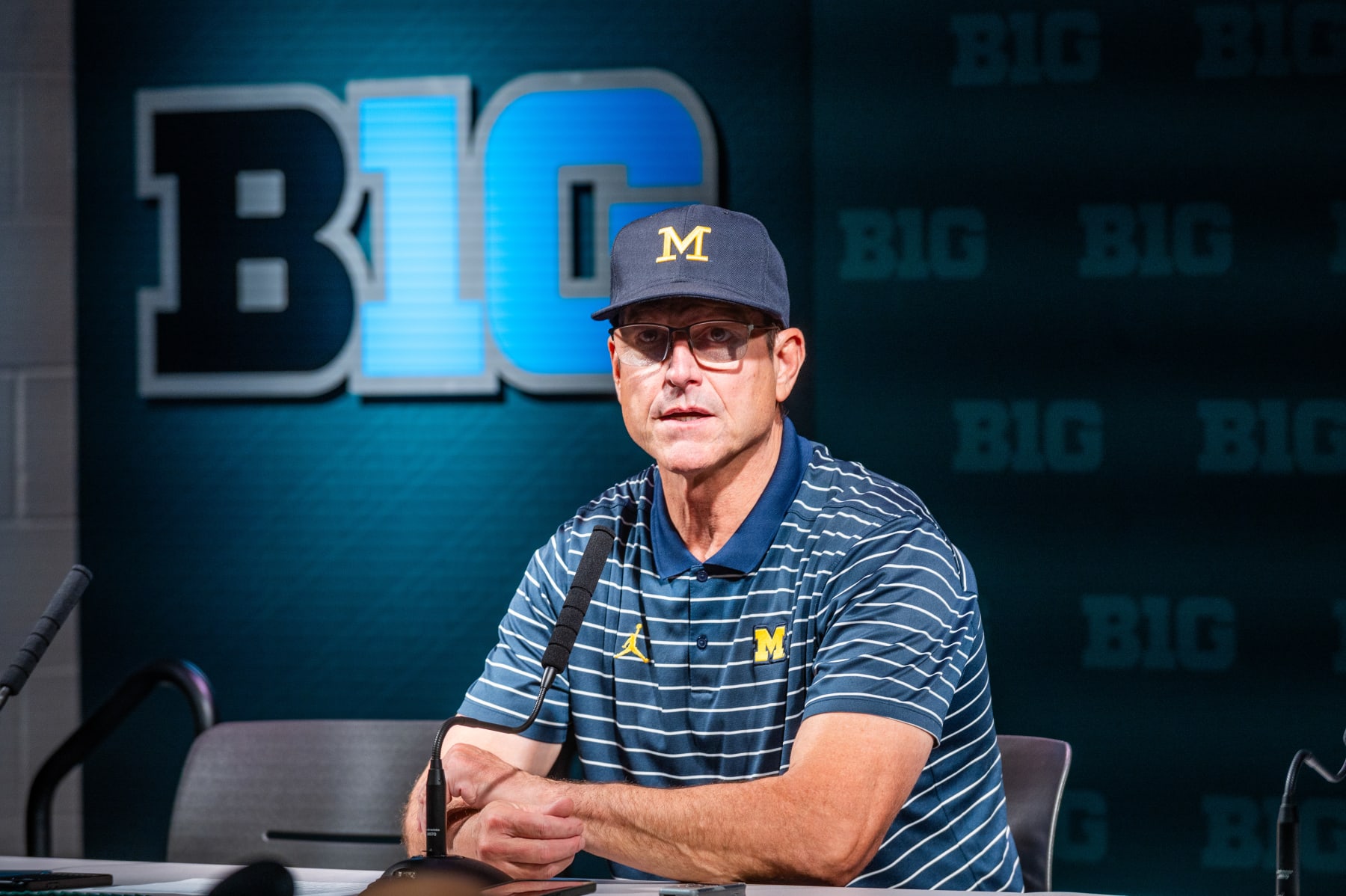 EAST LANSING, MICHIGAN - OCTOBER 21: Head coach Jim Harbaugh of the Michigan Wolverines speaks to media during the post game press conference after a college football game against the Michigan State Spartans at Spartan Stadium on October 21, 2023 in East Lansing, Michigan. The Michigan Wolverines won the game 49-0. (Photo by Aaron J. Thornton/Getty Images)
