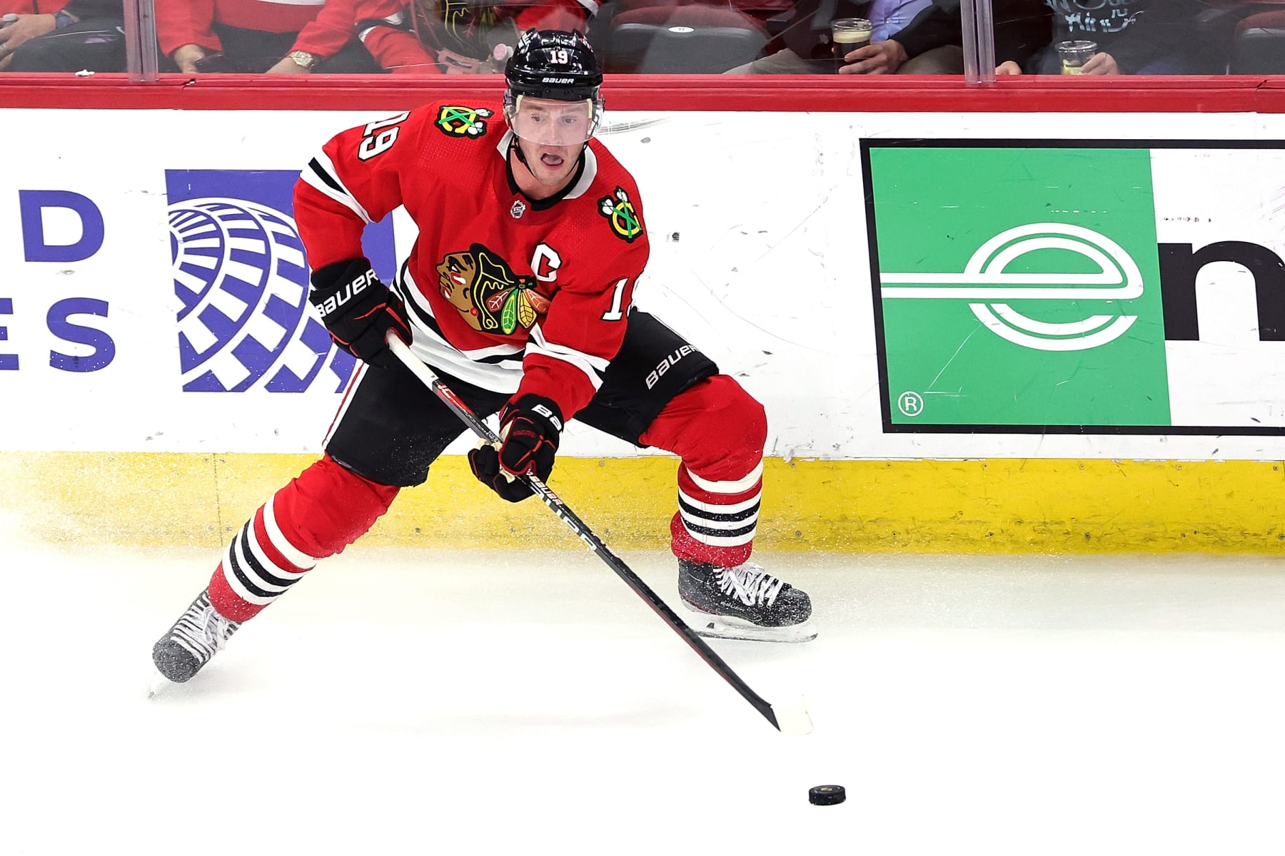 CHICAGO, ILLINOIS - APRIL 13: Jonathan Toews #19 of the Chicago Blackhawks controls the puck during a game against the Philadelphia Flyers at the United Center on April 13, 2023 in Chicago, Illinois.  The Flyers defeated the Blackhawks 5-4 in overtime. (Photo by Stacy Revere/Getty Images)