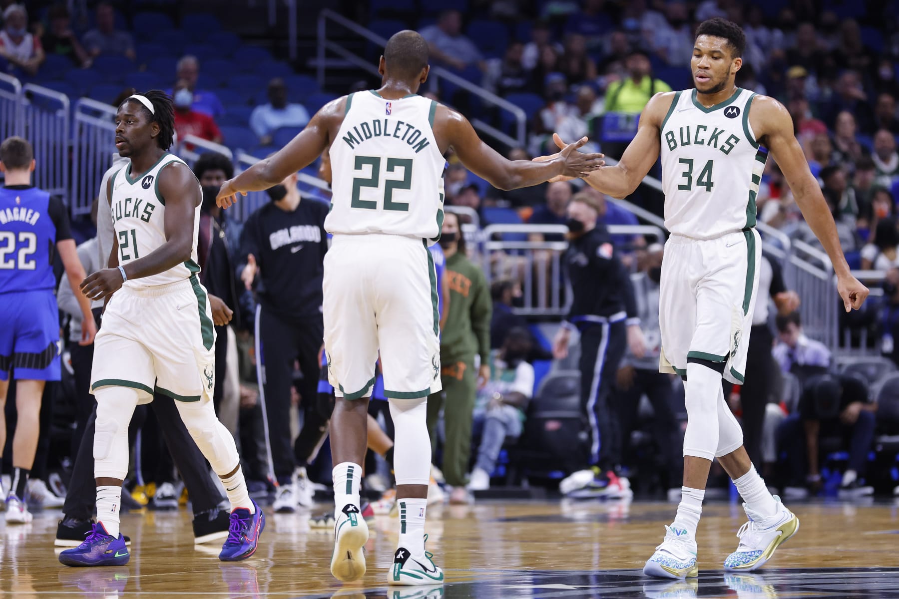 ORLANDO, FLORIDA - DECEMBER 30: Khris Middleton #22 and Giannis Antetokounmpo #34 of the Milwaukee Bucks high five \ah at Amway Center on December 30, 2021 in Orlando, Florida. NOTE TO USER: User expressly acknowledges and agrees that, by downloading and or using this photograph, User is consenting to the terms and conditions of the Getty Images License Agreement. (Photo by Michael Reaves/Getty Images)