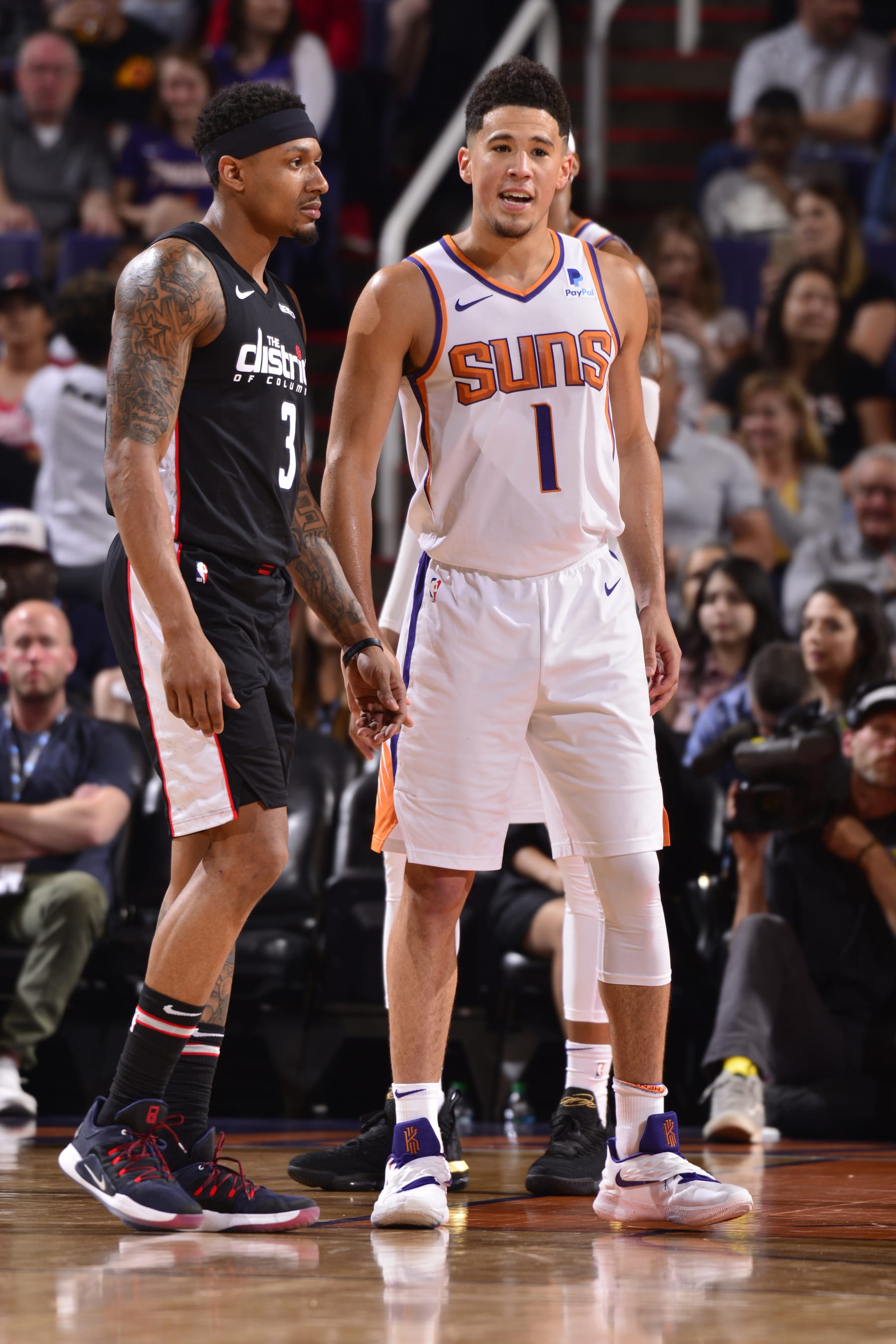 PHOENIX, AZ - MARCH 27: Bradley Beal #3 of the Washington Wizards and Devin Booker #1 of the Phoenix Suns look on during the game on March 27, 2019 at Talking Stick Resort Arena in Phoenix, Arizona. NOTE TO USER: User expressly acknowledges and agrees that, by downloading and or using this photograph, user is consenting to the terms and conditions of the Getty Images License Agreement. Mandatory Copyright Notice: Copyright 2019 NBAE (Photo by Barry Gossage/NBAE via Getty Images)