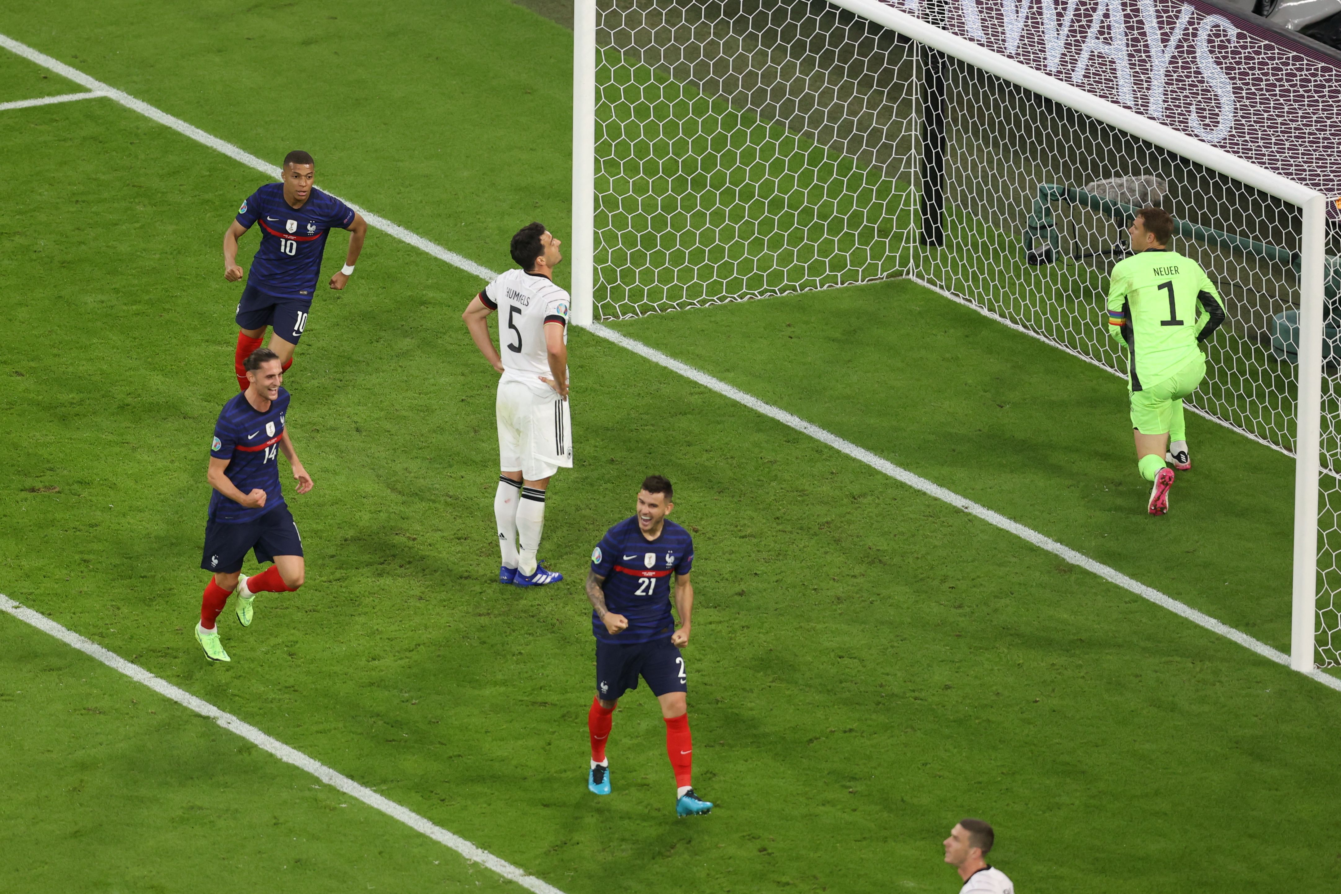 French players celebrate as Germany's defender Mats Hummels (C) reacts after deflecting the ball into his own net during the UEFA EURO 2020 Group F football match between France and Germany at the Allianz Arena in Munich on June 15, 2021. (Photo by ALEXANDER HASSENSTEIN / POOL / AFP) (Photo by ALEXANDER HASSENSTEIN/POOL/AFP via Getty Images)
