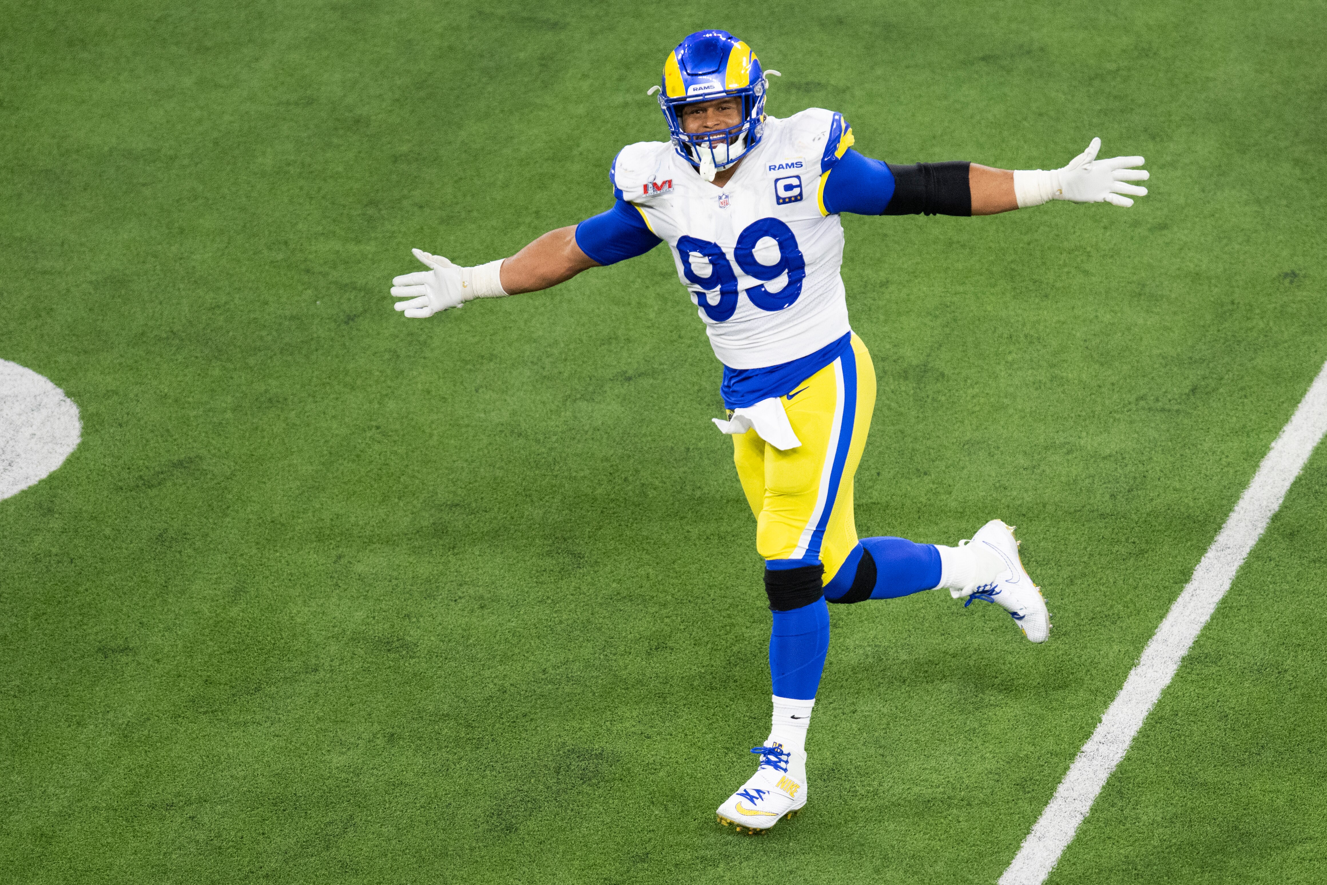 Los Angeles Rams defensive end Aaron Donald (99) reacts after forcing Cincinnati Bengals quarterback Joe Burrow (9) to throw an incomplete pass during the second half of the NFL Super Bowl 56 football game Sunday, Feb. 13, 2022, in Inglewood, Calif. (AP Photo/Kyusung Gong)