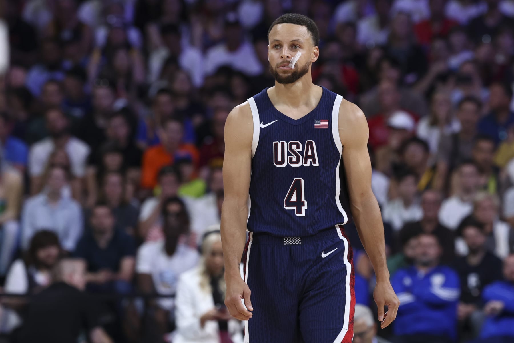 LILLE, FRANCE - JULY 28: Stephen Curry #4 of Team USA looks on during the Men's Group Phase - Group C match between Serbia and USA on Day 2 of the Olympic Games Paris 2024 at Stade Pierre Mauroy on July 28, 2024 in Lille, France. (Photo by Catherine Steenkeste/Getty Images)