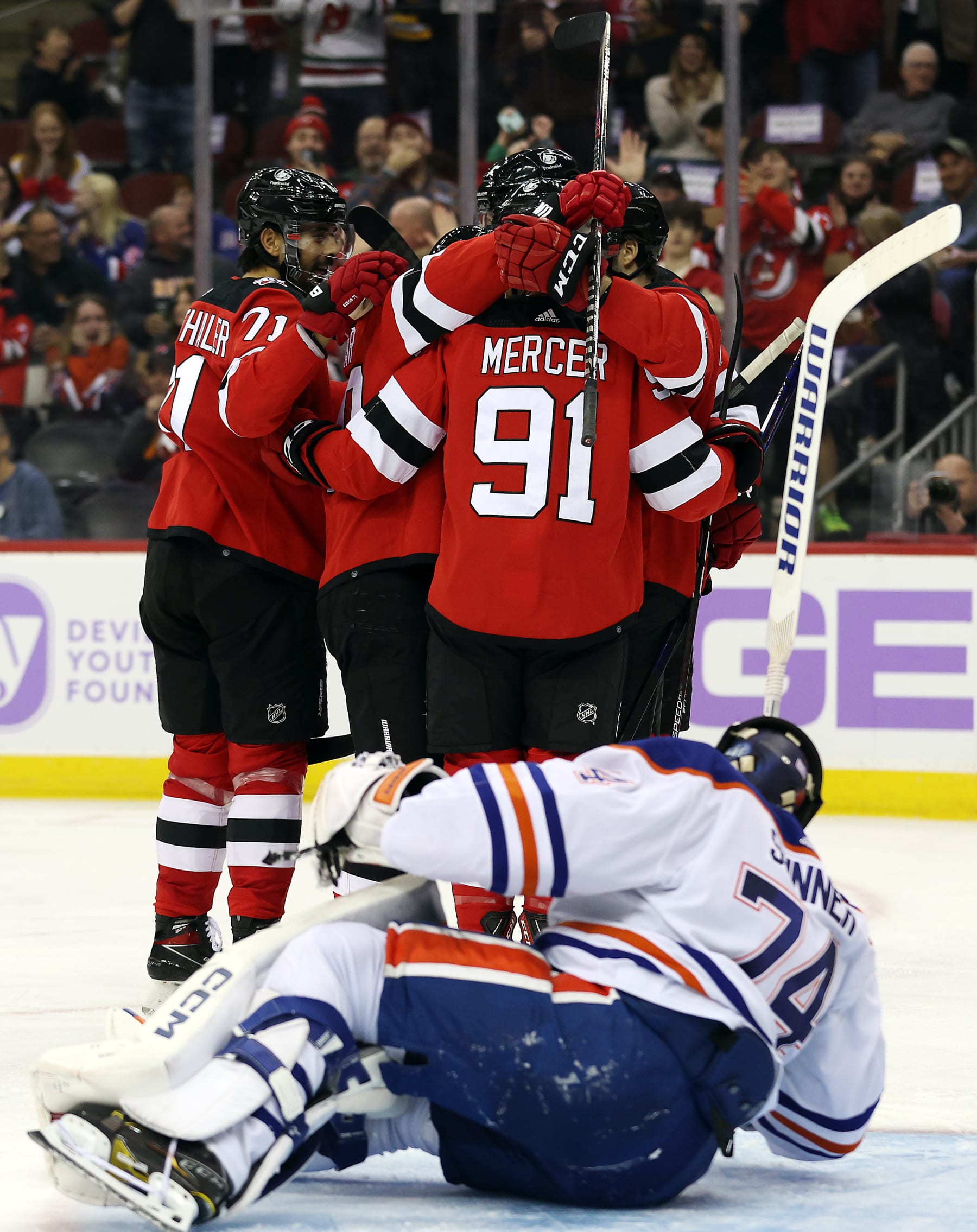 NEWARK, NEW JERSEY - NOVEMBER 21:  Dawson Mercer #91 of the New Jersey Devils is congratulated by teammates after scoring during the 2nd period of the game against the Edmonton Oilers at Prudential Center on November 21, 2022 in Newark, New Jersey. (Photo by Jamie Squire/Getty Images)