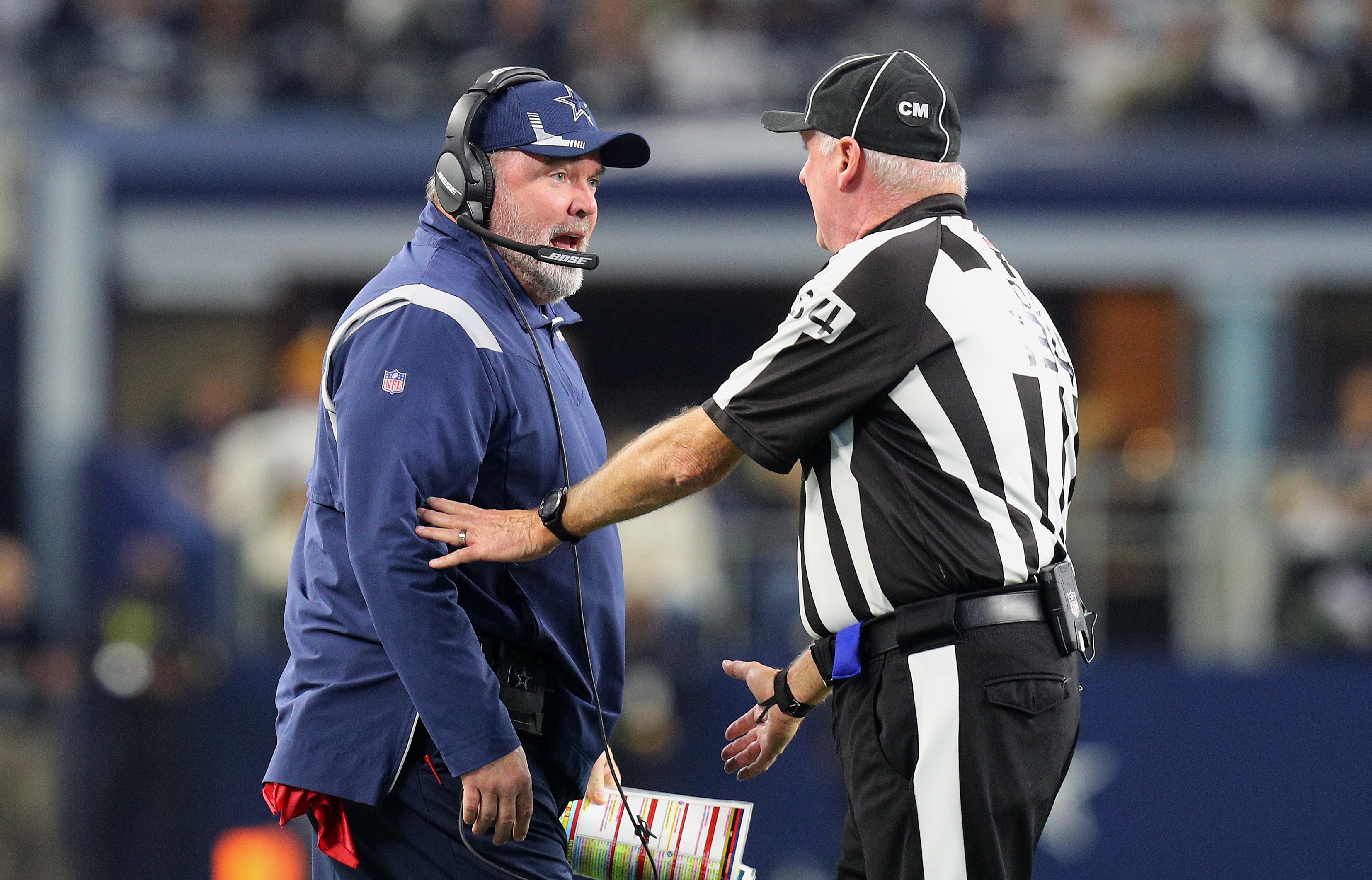 ARLINGTON, TEXAS - NOVEMBER 25: Head Coach Mike McCarthy of the Dallas Cowboys speaks to line judge Mark Steinkerchner #84 during the second quarter of the NFL game between Las Vegas Raiders and Dallas Cowboys at AT&T Stadium on November 25, 2021 in Arlington, Texas. (Photo by Richard Rodriguez/Getty Images)