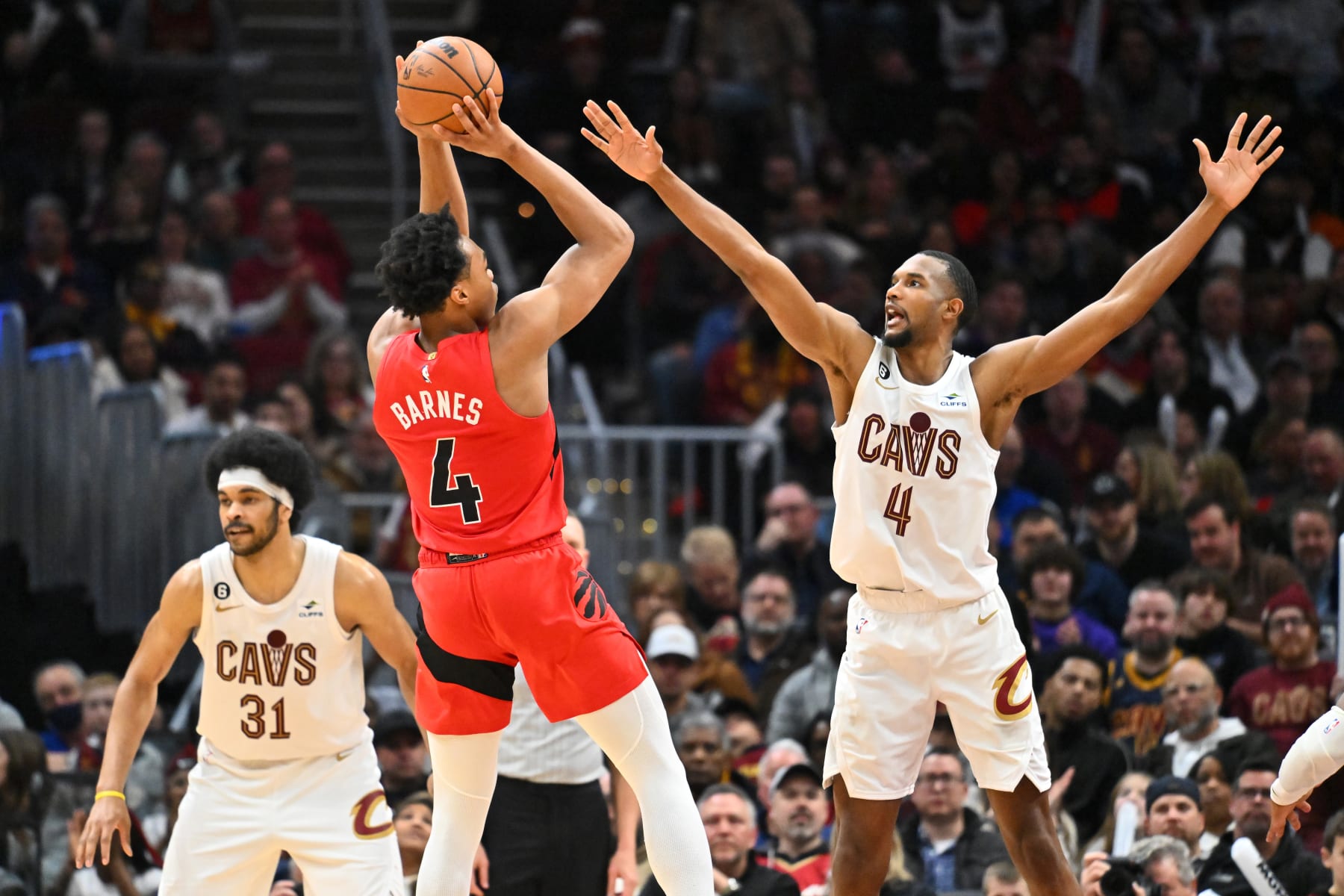 CLEVELAND, OHIO - FEBRUARY 26: Evan Mobley #4 of the Cleveland Cavaliers guards Scottie Barnes #4 of the Toronto Raptors during the 3rd quarter at Rocket Mortgage Fieldhouse on February 26, 2023 in Cleveland, Ohio. The Cavaliers defeated the Raptors 118-93. NOTE TO USER: User expressly acknowledges and agrees that, by downloading and or using this photograph, User is consenting to the terms and conditions of the Getty Images License Agreement. (Photo by Jason Miller/Getty Images)