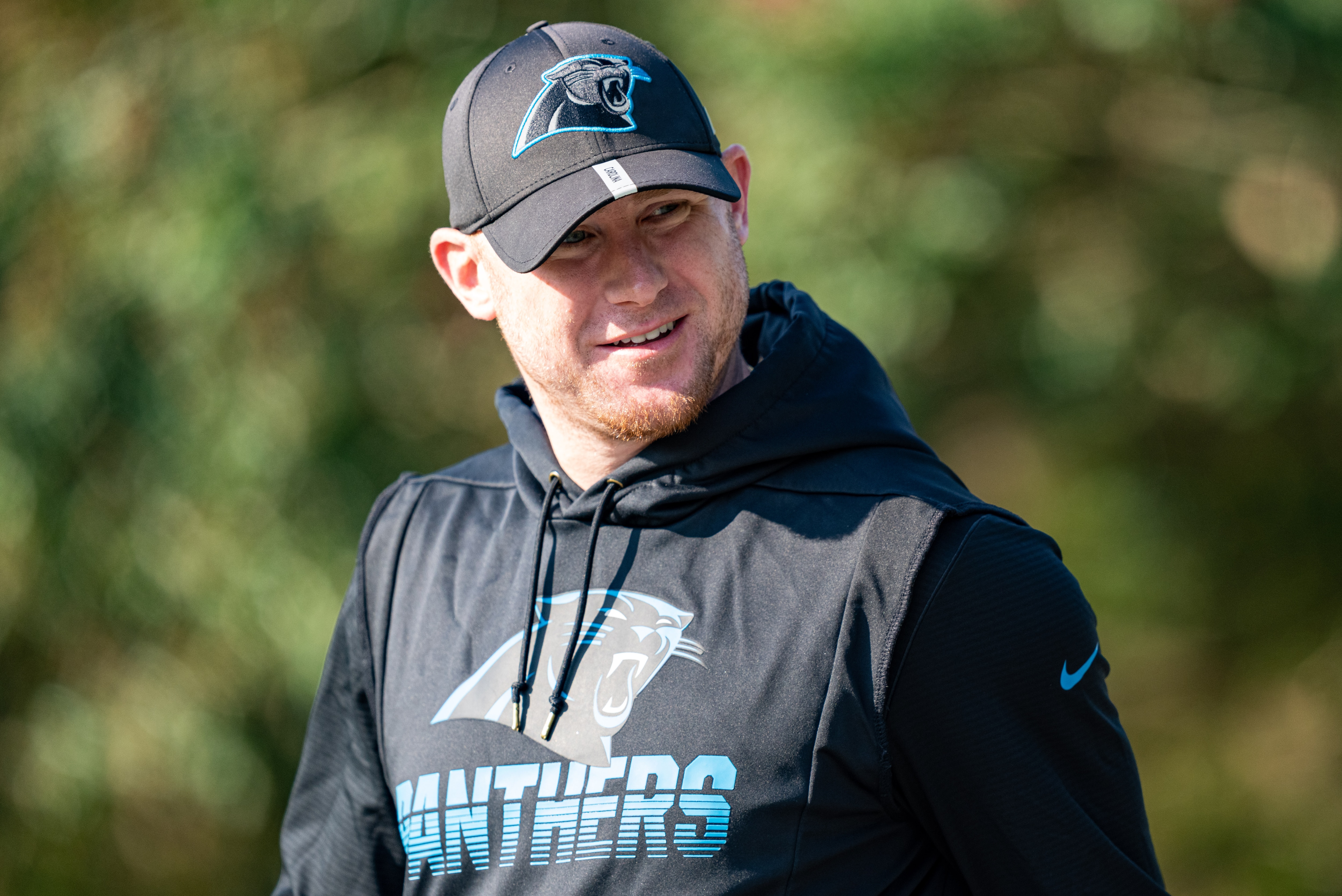 SPARTANBURG, SOUTH CAROLINA - AUGUST 08: Joe Brady of the Carolina Panthers walks onto the field during their training camp on August 08, 2021 in Spartanburg, South Carolina. (Photo by Jacob Kupferman/Getty Images)