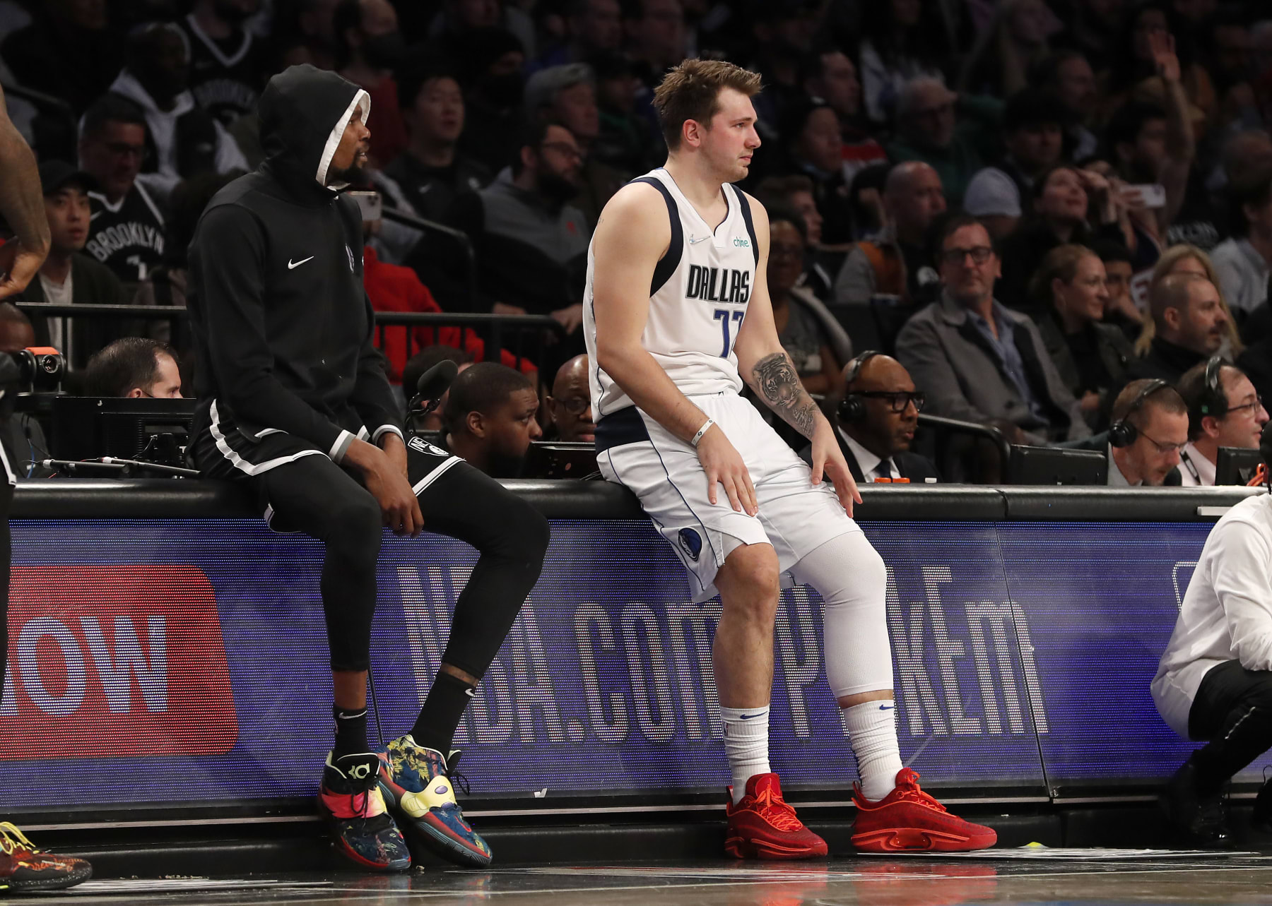 NEW YORK, NEW YORK - MARCH 16: (NEW YORK DAILIES OUT)  Luka Doncic #77 of the Dallas Mavericks and Kevin Durant #7 of the Brooklyn Nets look on at Barclays Center on March 16, 2022 in New York City. The Mavericks defeated the Nets 113-111. NOTE TO USER: User expressly acknowledges and agrees that, by downloading and or using this photograph, User is consenting to the terms and conditions of the Getty Images License Agreement. (Photo by Jim McIsaac/Getty Images)