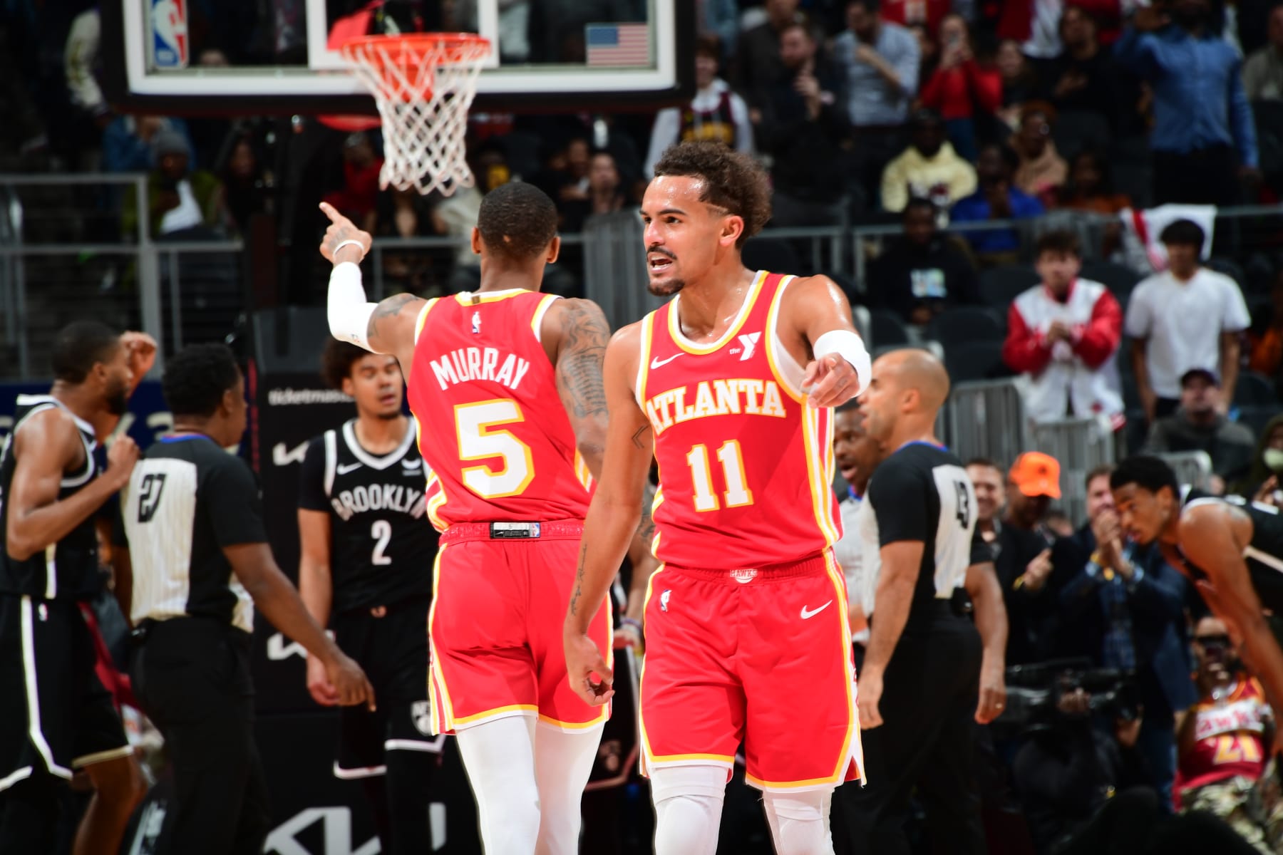 ATLANTA, GA - DECEMBER 6: Dejounte Murray #5 and Trae Young #11 of the Atlanta Hawks stand on the court during the game against the Brooklyn Nets on December 6, 2023 at State Farm Arena in Atlanta, Georgia.  NOTE TO USER: User expressly acknowledges and agrees that, by downloading and/or using this Photograph, user is consenting to the terms and conditions of the Getty Images License Agreement. Mandatory Copyright Notice: Copyright 2023 NBAE (Photo by Scott Cunningham/NBAE via Getty Images)